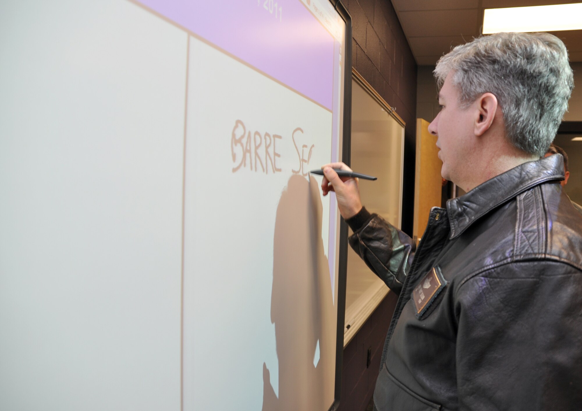 Col. Barre Seguin, 14th FTW commander, takes a turn at writing on one the new Columbus Middle School’s “smart boards” Jan. 13 during a tour of the facility. Each classroom in the newly constructed facility houses one of these interactive boards that allow teachers a multitude of innovative tools to instruct with. (U.S. Air Force photo/Staff Sgt. Jacob Corbin).