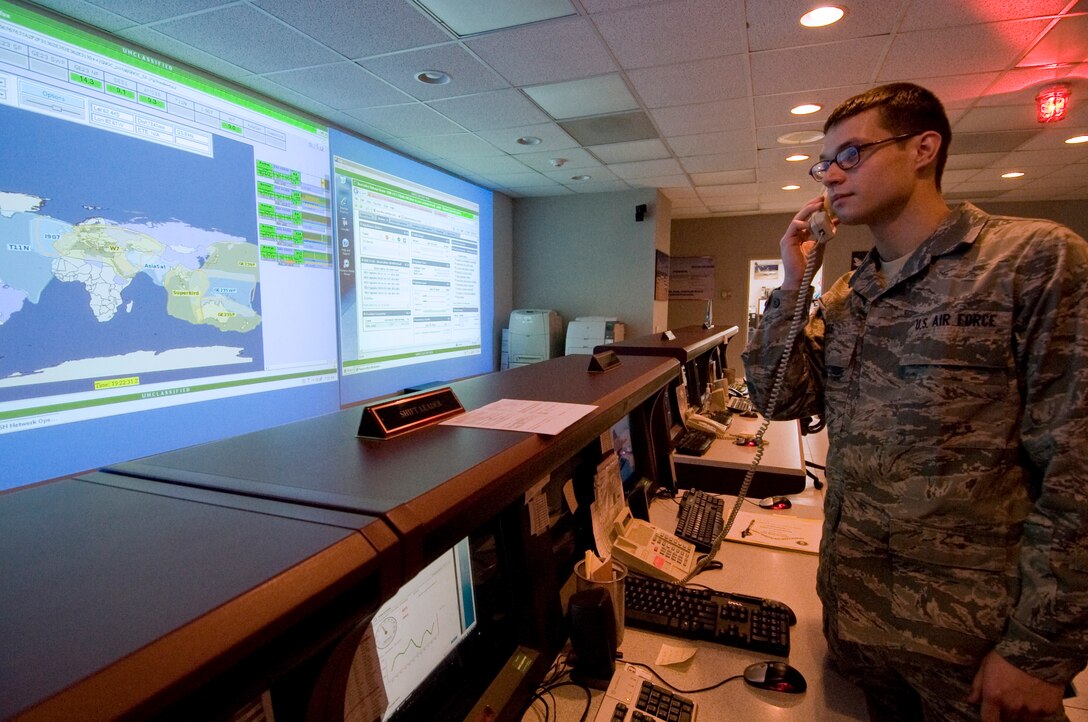 ANDREWS AIR FORCE BASE, Md. -- Airman 1ST Class Parker Nicks, 89th Communications Squadron Global Network Operations Center systems analyst, adjusts bandwidth for a video teleconference between an airborne distinguished visitor and another senior government official inside the GNOC hub Jan. 12. The 89 CS utilizes a high frequency global communications system to provide rapid, reliable, non-dedicated secure, non-secure voice or data communications support to the president, cabinet members, DoD agencies, aircraft, and U.S ships during peacetime, contingency operations and war.  (U.S. Air Force photo/Bobby Jones)