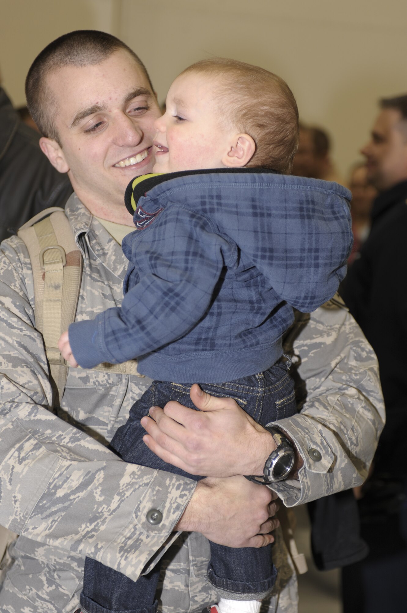 Staff Sgt. Sean Szekeresh, 16th Special Operations Squadron, reunites with his son Kale in Hangar 196 following his return to Cannon Air Force Base, N.M.,   from deployment Jan.10, 2011. Sergeant Szekeresh's family were one of the many that gathered to welcome home their Air Commando's. (U.S. Air Force Photo by Airman Ericka Engblom) 