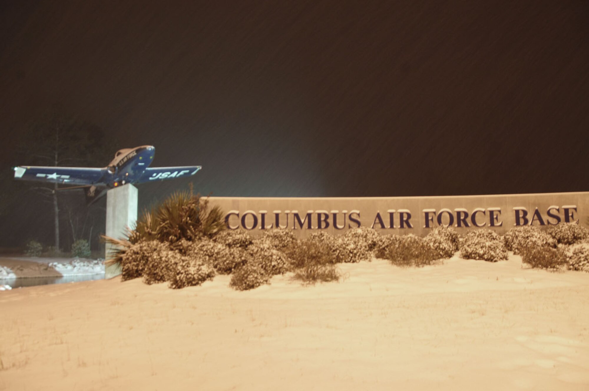 Snow falls on the Columbus Air Force Base welcome sign during a winter snow storm Jan. 9. The storm left just over three inches of snow and resulted in delayed reporting for most base members Jan. 10. (U.S. Air Force photo/Staff Sgt. Bryan Franks). 