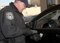 James Ramos, a base security officer, scans a Common Access Card with a Defense Biometric Identification System at Lackland's Valley Hi Gate Jan. 11. DBIDS, an identity authentication and force protection program, is being implemented across Joint Base San Antonio. (U.S. Air Force photo/Robbin Cresswell)
