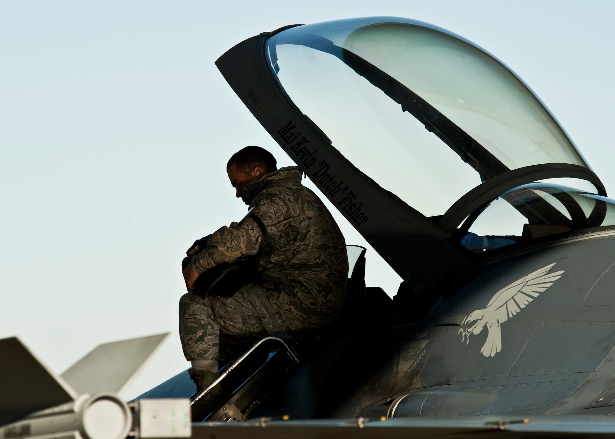 An F-16 crew chief from Luke Air Force Base, Ariz., prepares the aircraft for beddown at Eglin Air Force Base, Fla., Jan. 13.  Four F-16s from Luke were brought to the wing to help prepare the pilots and maintainers for the imminent arrival of the F-35 Joint Strike Fighter.  (U.S. Air Force photo/Samuel King Jr.)