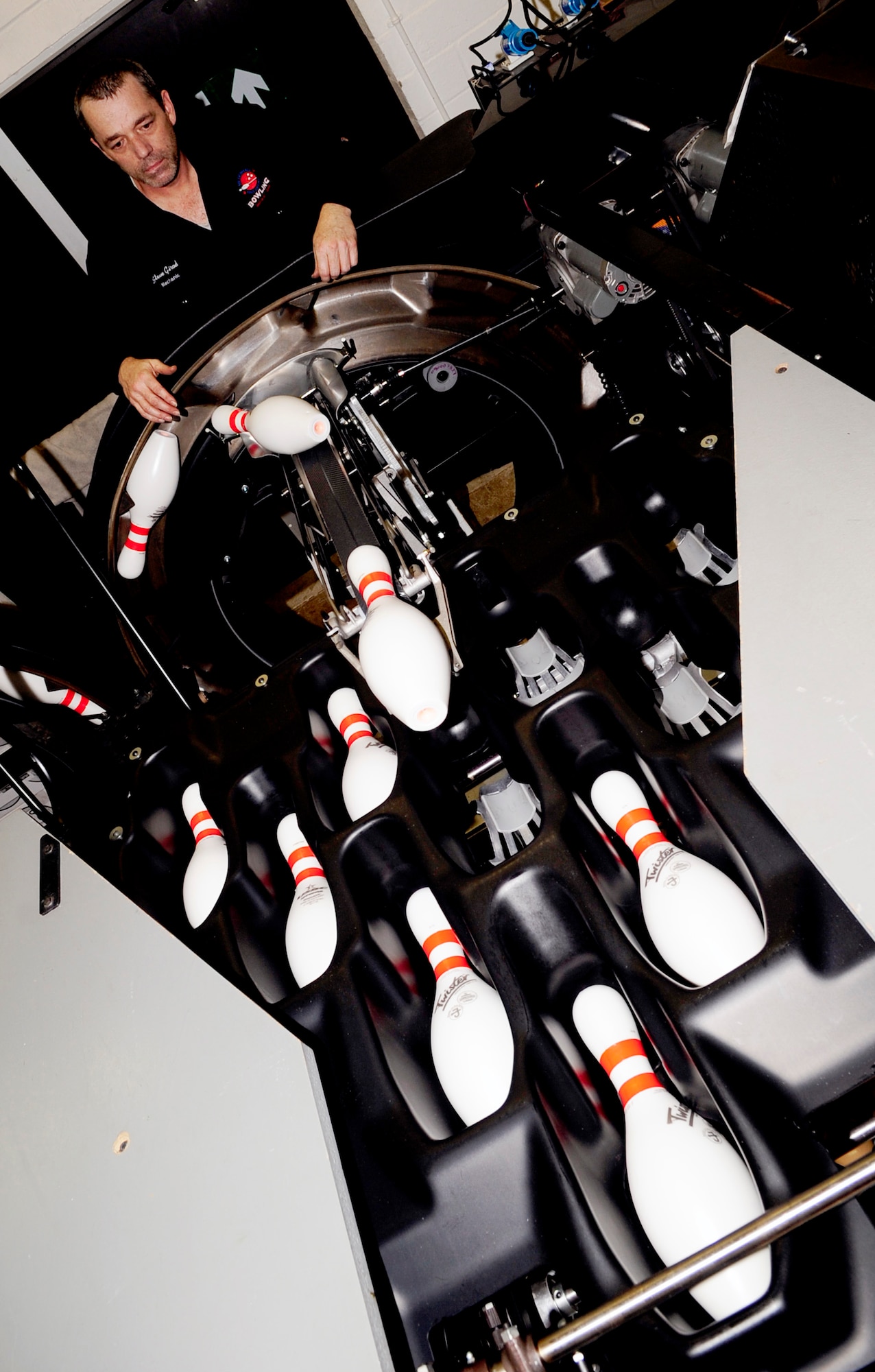 RAF MILDENHALL, England -- Steve Girod, 100th Force Support Squadron mechanic, checks to ensure the Durabin Field Upgrade works properly after installing it Jan. 13, 2011. The Durabin has more than 200 less parts and 20 percent fewer pin jams than its predecessor allowing the base to save time and money on parts and labor. (U.S. Air Force photo/Senior Airman Ethan Morgan)
