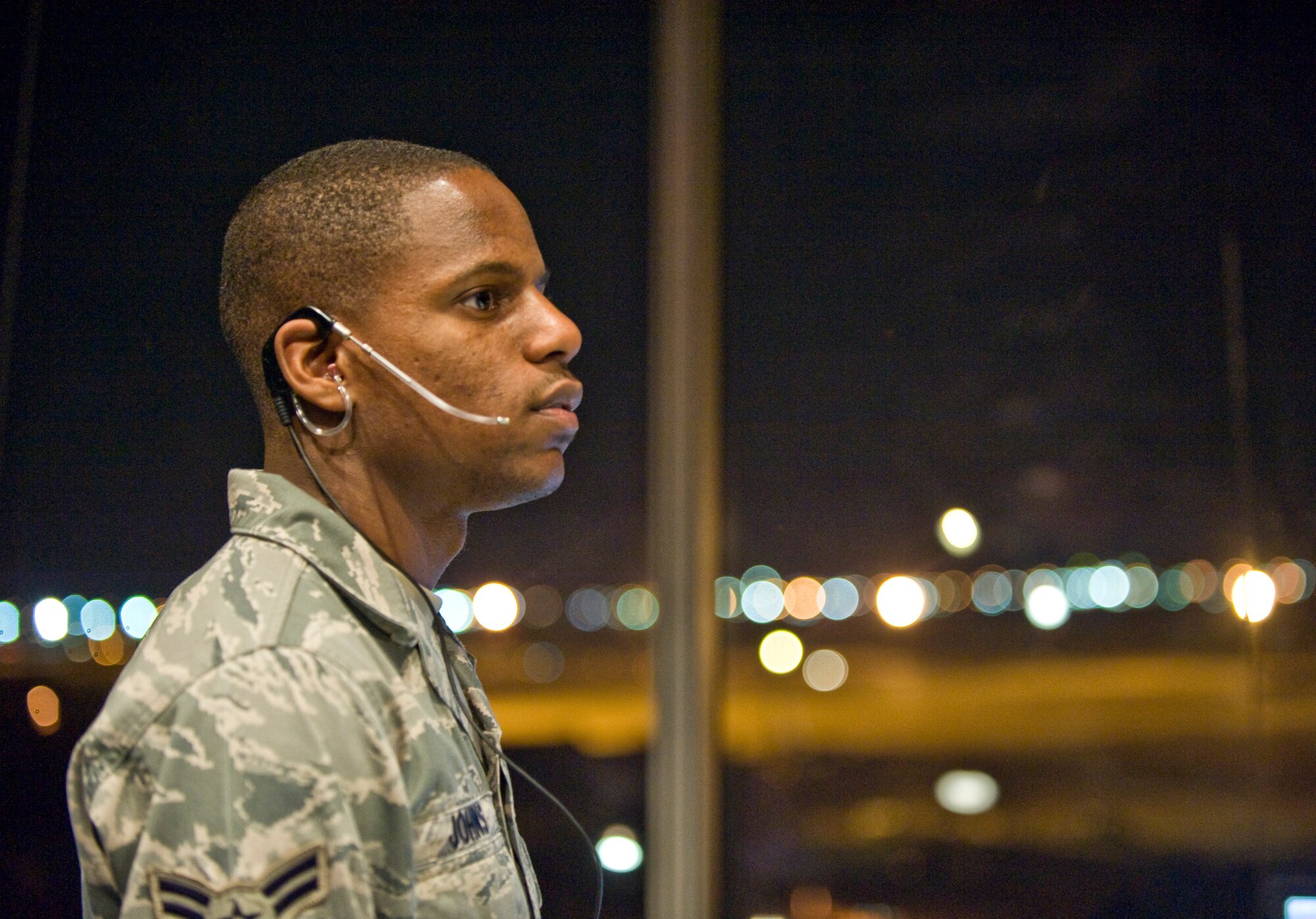 Airman 1st Class Courtney Johns, an air traffic controller with the 2nd Operations Support Squadron, watches over the airfield from the control tower on Barksdale Air Force Base, La., Jan. 12. ATCs undergo intense training and evaluation before they are certified to control aircraft. Due to the high volume of training missions accomplished here, ATCs must man the tower 24/7. (U.S. Air Force photo/Senior Airman Chad Warren)(RELEASED)