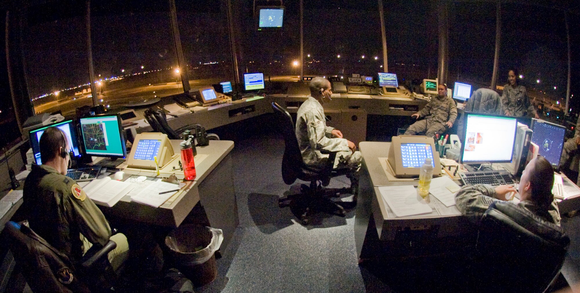 Air traffic controllers with the 2nd Operations Support Squadron await the next incoming aircraft from the control tower on Barksdale Air Force Base, La., Jan. 12. Air traffic controllers control the movement of aircraft into and out of military airfields by tracking multiple aircraft simultaneously using radar and radio communication. Due to the high volume of training missions accomplished here, ATCs must man the tower 24/7. (U.S. Air Force photo/Senior Airman Chad Warren)(RELEASED)