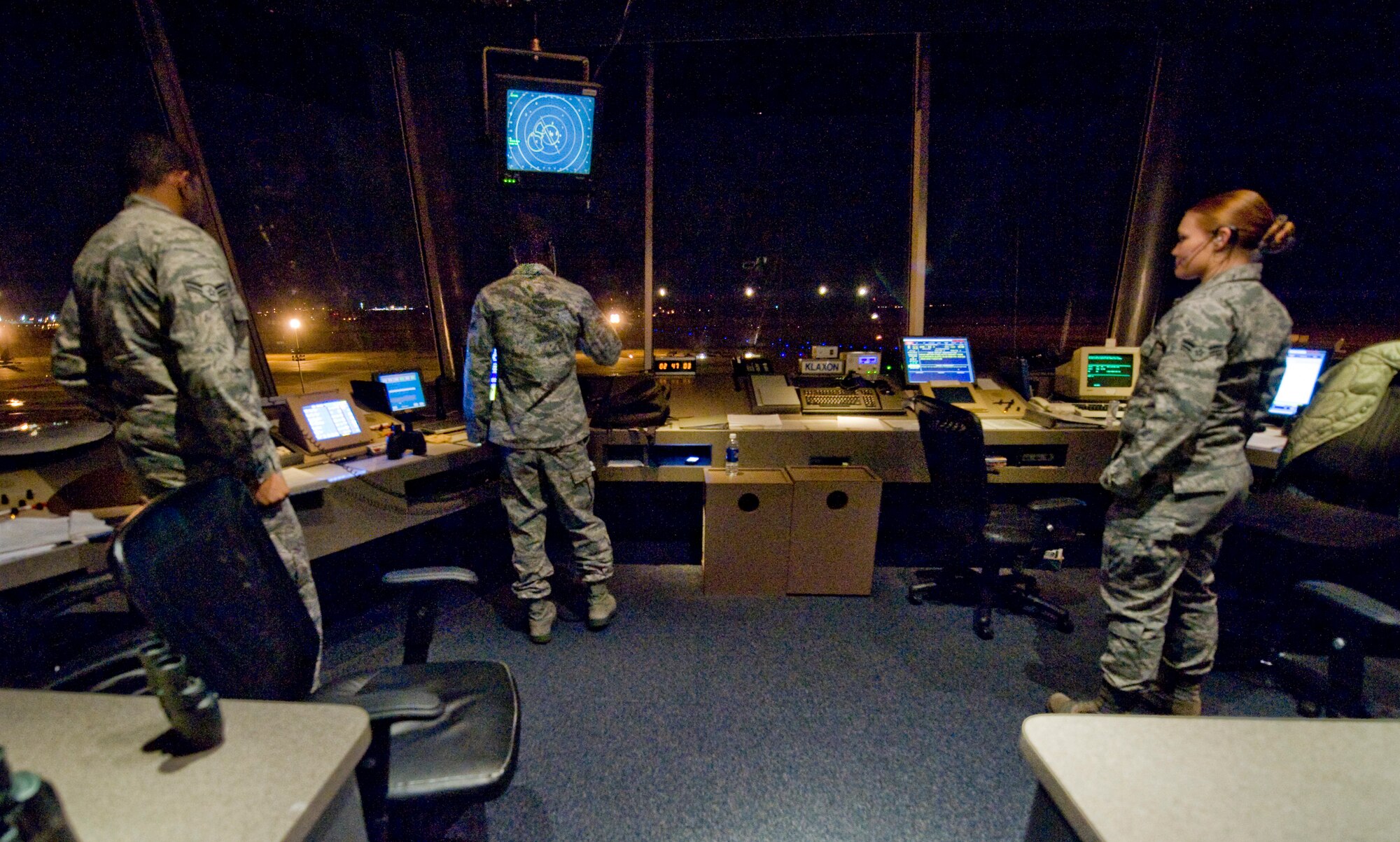 Air traffic controllers with the 2nd Operations Support Squadron communicate with an approaching pilot from the control tower on Barksdale Air Force Base, La., Jan. 12. Due to the high volume of training missions accomplished here, ATCs must man the tower 24/7. (U.S. Air Force photo/Senior Airman Chad Warren)(RELEASED)