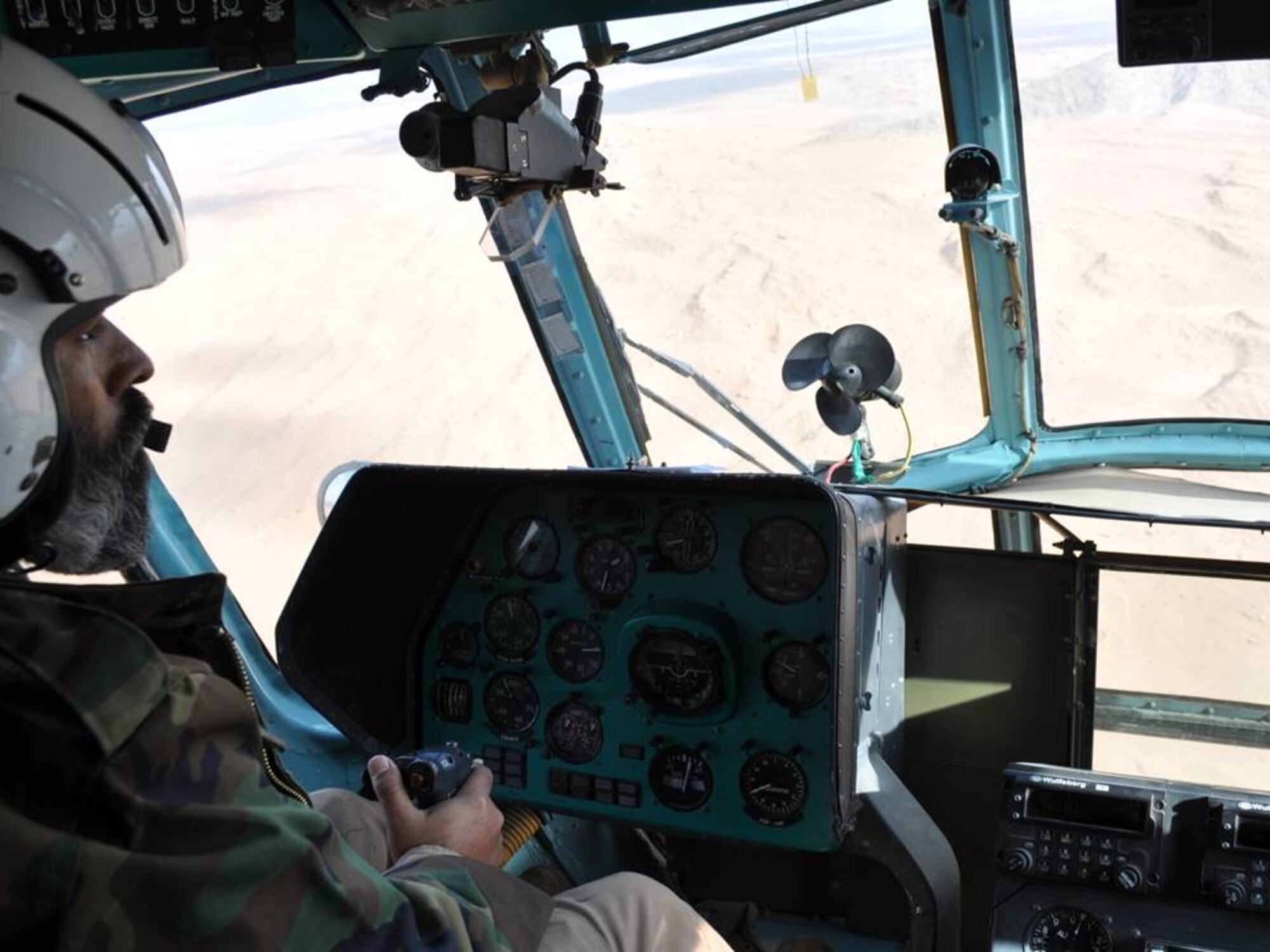 MUSA QAL’AH, Afghanistan - Major Azizullah (surrounded by youth), the Afghan Air Force 379th Rotary Wing Squadron Operation Officer, answers question on becoming an AAF pilot to 40 young men on Dec 20.  (U.S. Air Force photo/RELEASED).