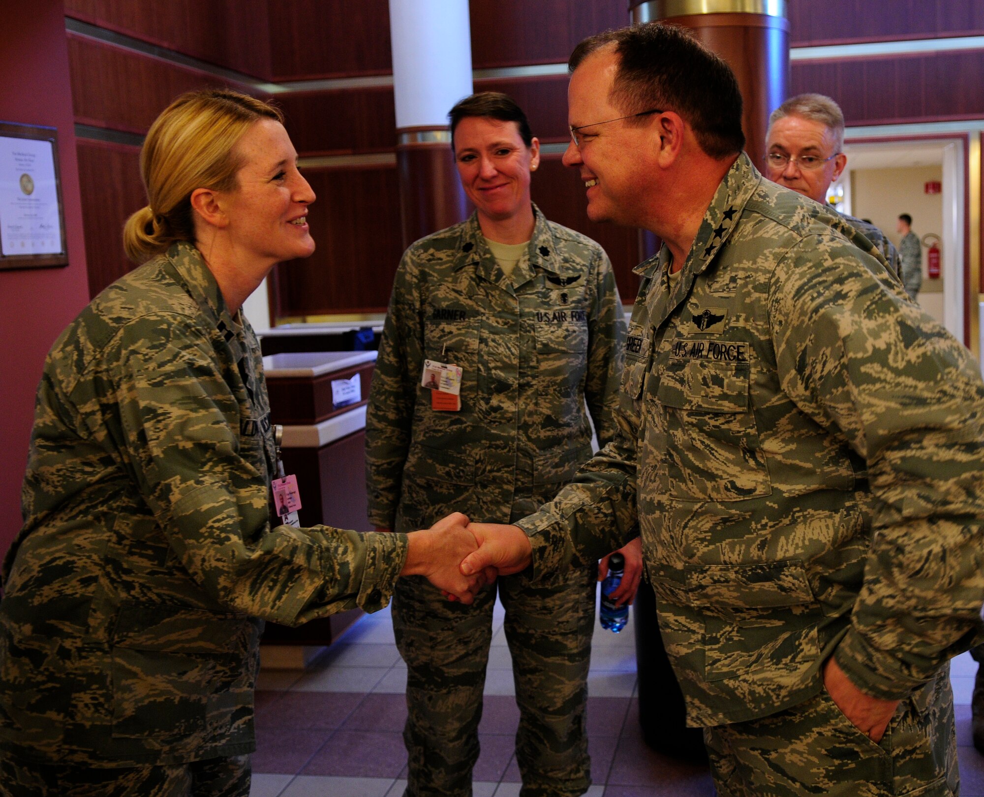 Capt. Gretchen Waldvogel, 31st Surgical Operations Squadron, receives a coin from Lt. Gen. (Dr.) Charles B. Green, Air Force Surgeon General, at the 31st Medical Group Hospital Jan. 12.  Aviano Air Base was the first stop on the surgeon general’s USAFE tour, which aims to educate military health care providers on a new initiative that will be implemented in June 2011. (U.S. Air Force photo by Airman 1st Class Katherine Windish)