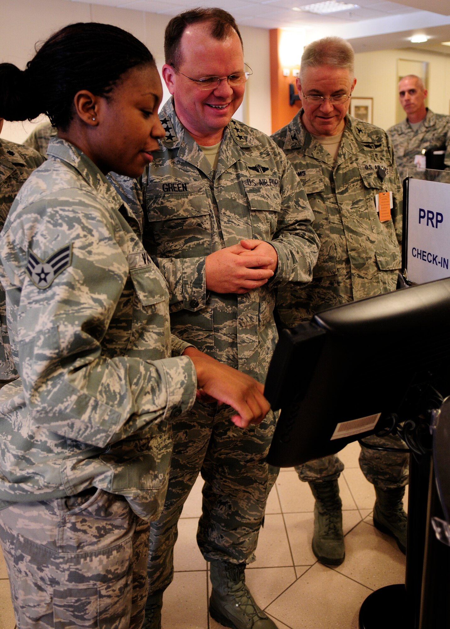 Senior Airman Jaleesa S. Vason, 31st Surgical Operations Squadron, shows Lt. Gen. (Dr.) Charles B. Green, Air Force Surgeon General, how 31st Medical Group Hospital check-in system works Jan. 12.  Aviano Air Base was the first stop on the surgeon general’s USAFE tour, which aims to educate military health care providers on a new initiative that will be implemented in June 2011. (U.S. Air Force photo by Airman 1st Class Katherine Windish)