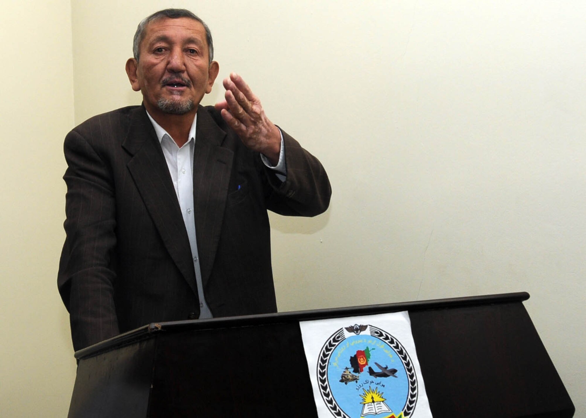 KABUL, Afghanistan - Guest speaker, Kazma Sarwi, an Afghan Instructor, speaks at a graduation of 30 Afghan Air Force members from 4 different courses at Pohantoon-e-Hawayee, the Afghan Air Force's "BIg Air School" in Kabul, Afghanistan, on Jan. 13. (U.S. Navy photo by Mass Communications Specialist 3rd Class Petty Officer Jared E. Walker/ RELEASED).