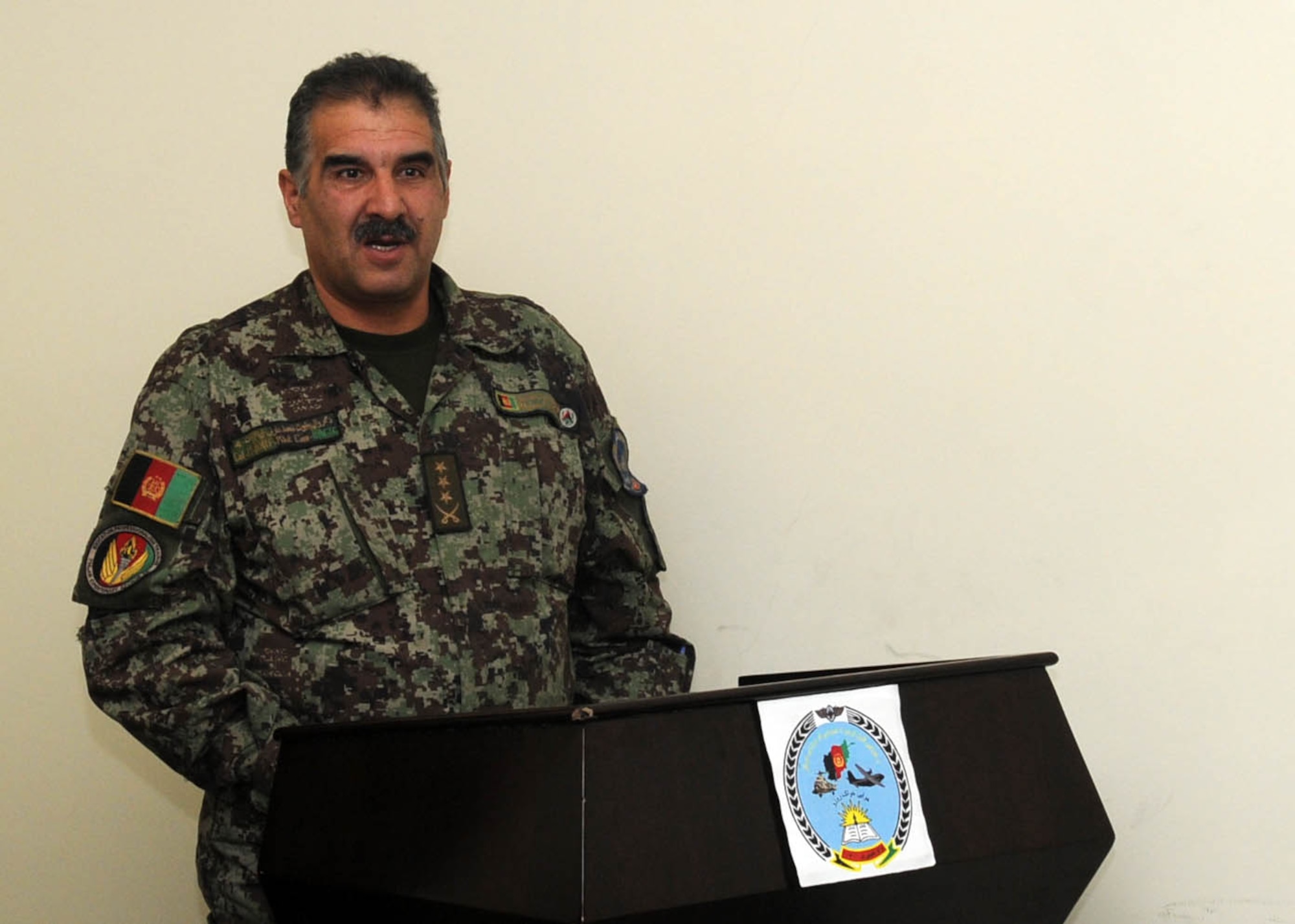 KABUL, Afghanistan - Guest speakers speak at a graduation of 30 Afghan Air Force members from 4 different courses at Pohantoon-e-Hawayee, the Afghan Air Force's "BIg Air School" in Kabul, Afghanistan, on Jan. 13. (U.S. Navy photo by Mass Communications Specialist 3rd Class Petty Officer Jared E. Walker/ RELEASED).