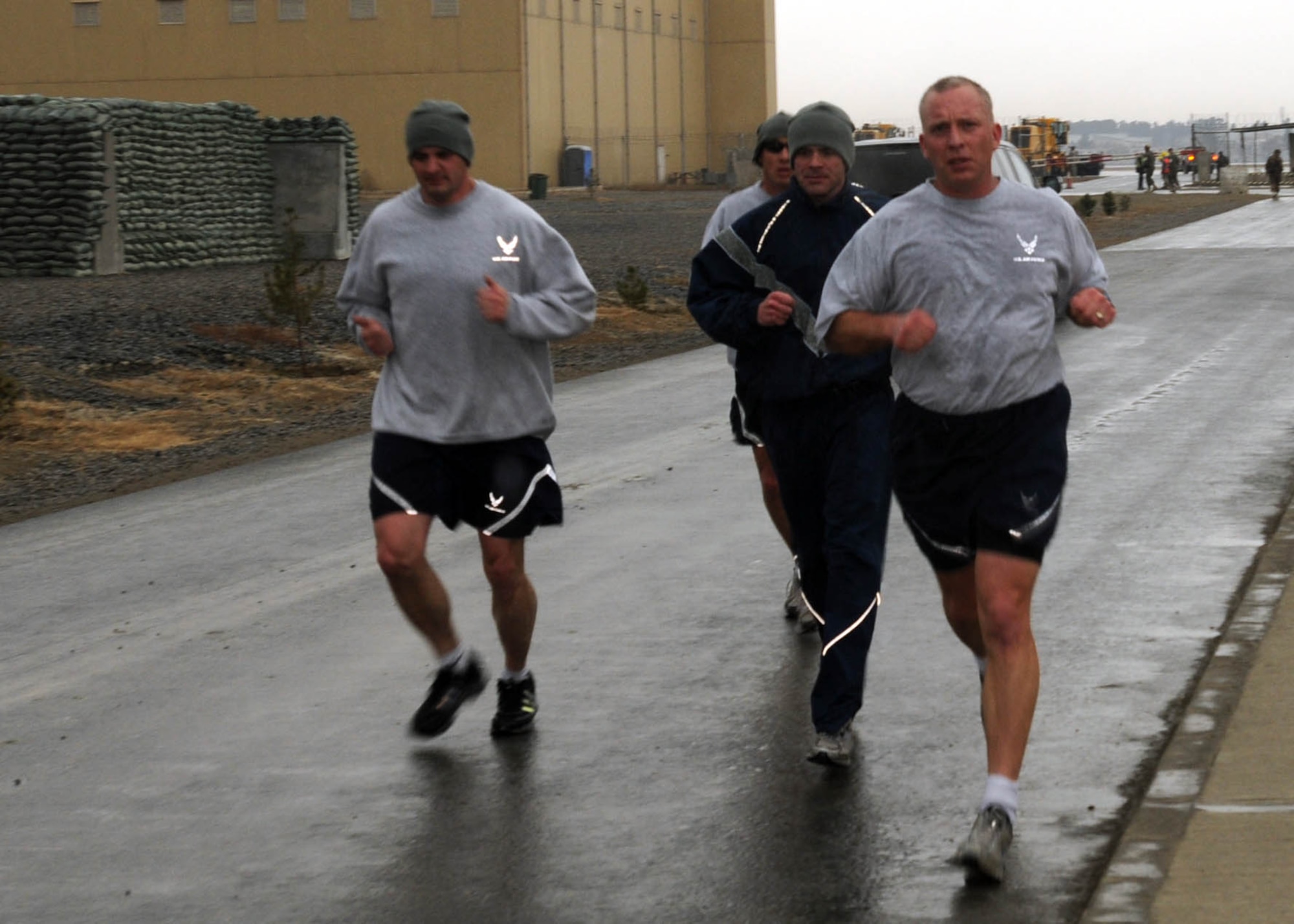 KABUL, Afghanistan - Members of the 438th Air Expeditionary Wing join together in a snowy two mile group run around the Afghan Air Force Base in Kabul, Afghanistan. (U.S. Navy photo by Mass Communications Specialist 3rd Class Petty Officer Jared E. Walker/ RELEASED).