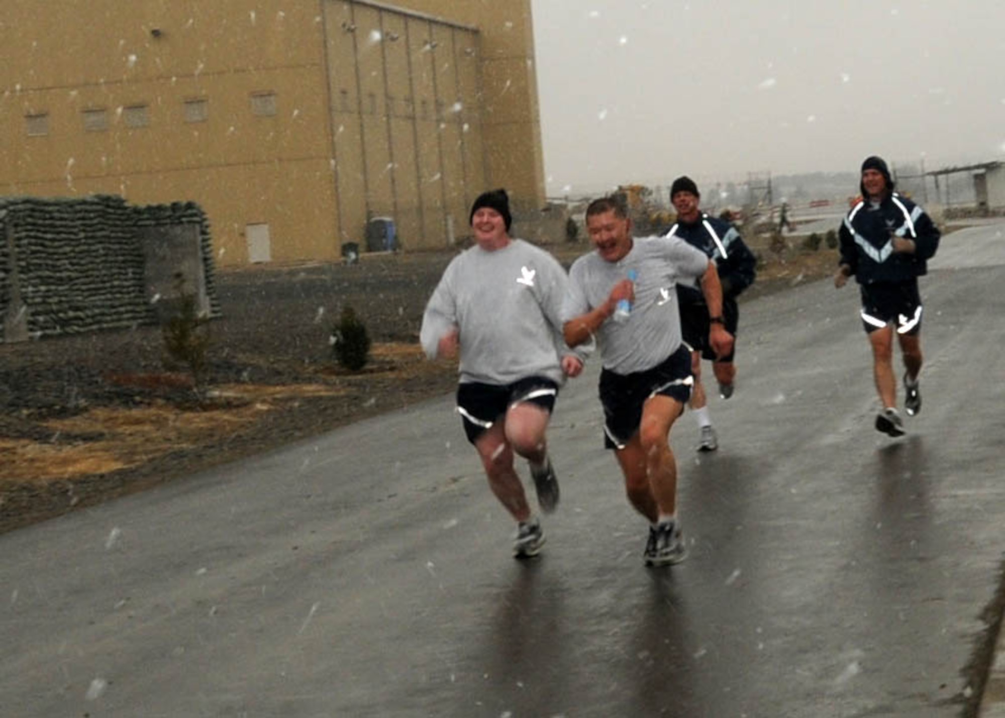 KABUL, Afghanistan - Members of the 438th Air Expeditionary Wing join together in a snowy two mile group run around the Afghan Air Force Base in Kabul, Afghanistan. (U.S. Navy photo by Mass Communications Specialist 3rd Class Petty Officer Jared E. Walker/ RELEASED).