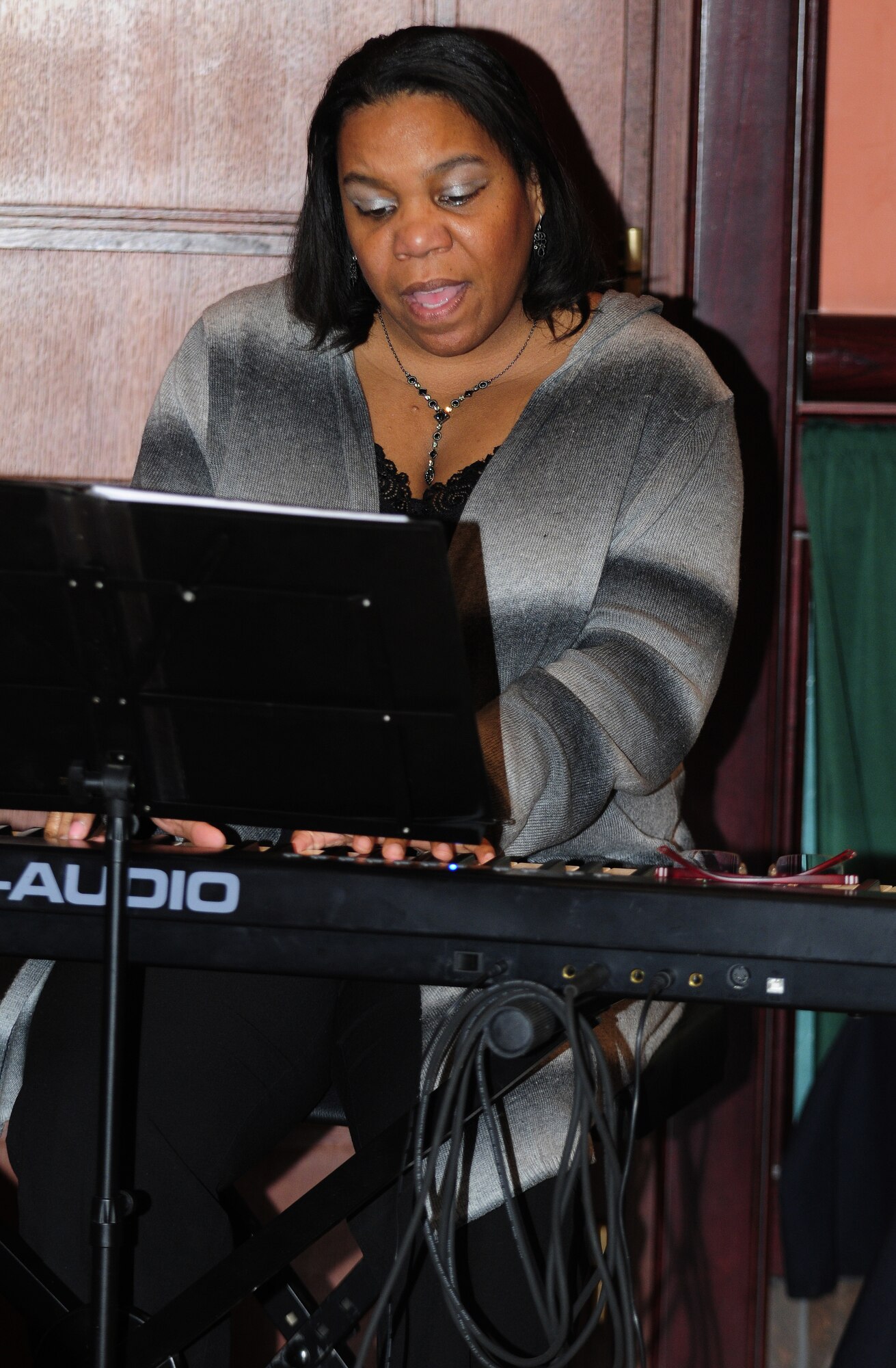Jovone Lewis, 31st Logistics Readiness Squadron commander’s secretary, sings “Shed a Little Light” in honor of Martin Luther King Jr. during a luncheon dedicated to the civil rights activist Jan. 13 at La Bella Vista Club. Martin Luther King Jr. Day is a federal holiday held annually on the third Monday of January to commemorate the clergyman’s achievements during the Civil Rights Movement in the 1950s and 1960s. (U.S. Air Force photo by Airman 1st Class Katherine Windish)