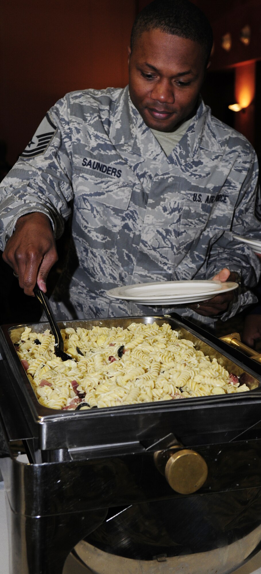 Master Sgt. Jonathan Saunders, 31st Logistics Readiness Squadron vehicle operations NCO in charge, serves himself food during a luncheon dedicated to Martin Luther King Jr. Jan. 13 at La Bella Vista Club. Martin Luther King Jr. Day is a federal holiday held annually on the third Monday of January to commemorate the clergyman’s achievements during the Civil Rights Movement of the 1950’s and 1960s. (U.S. Air Force photo by Airman 1st Class Katherine Windish)