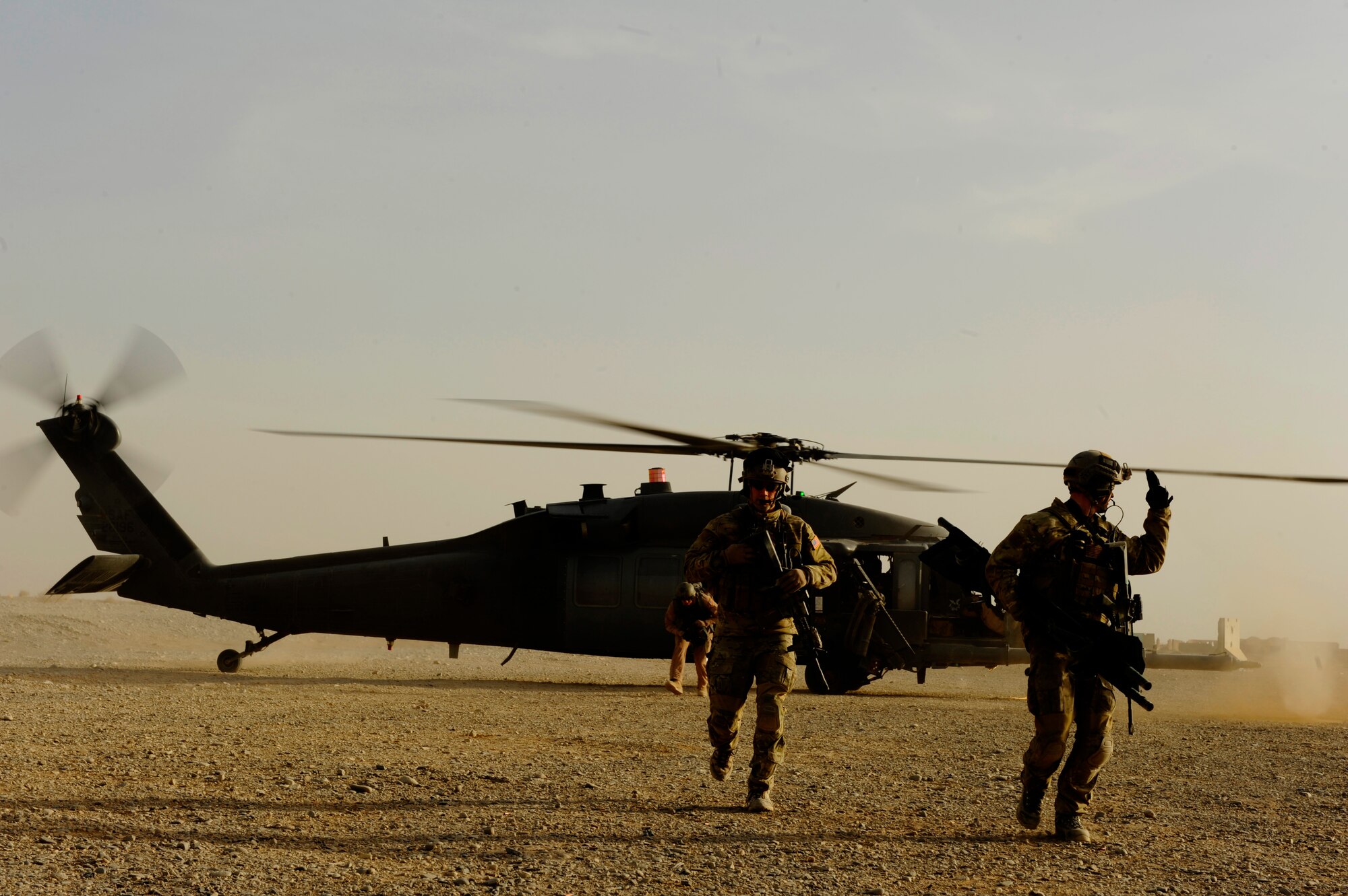 U.S. Air Force Capt. Nick Morgans, 46th Expeditionary Rescue Squadron, and Tech. Sgt. Anthony Wood return to treat more casualties after loading one onto an HH-60 Pave Hawk during a mass casualty scenario near Kandahar, Afghanistan, Dec. 24, 2010.  The scenario was planned as part of Sgt. Wood's qualification to become an element lead.  (U.S. Air Force Photo/Staff Sgt. Eric Harris) (RELEASED)
