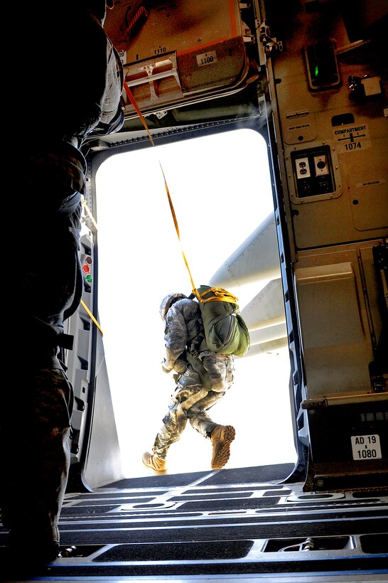 A member of the 36th Contingency Response Group jumps out of a door while conducting static line jump training from a C-17 Globemaster III over Andersen Air Force Base, Guam, Jan. 11, 2011.