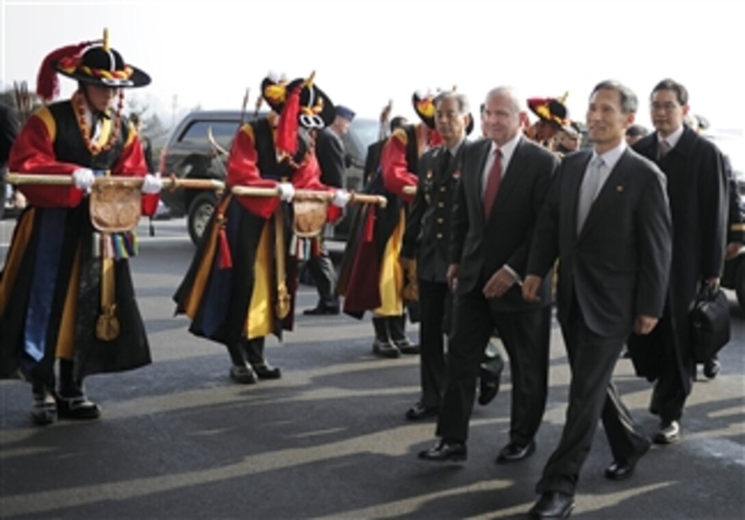 Secretary of Defense Robert M. Gates is escorted by Korean National Defense Minister Kim Kwan-jin after arriving in Seoul, Republic of Korea, on Jan. 14, 2011.  Gates is meeting with President Lee Myung-bak and Defense Minister Kim Kwan-jin to discuss U.S and Korean defense issues.  