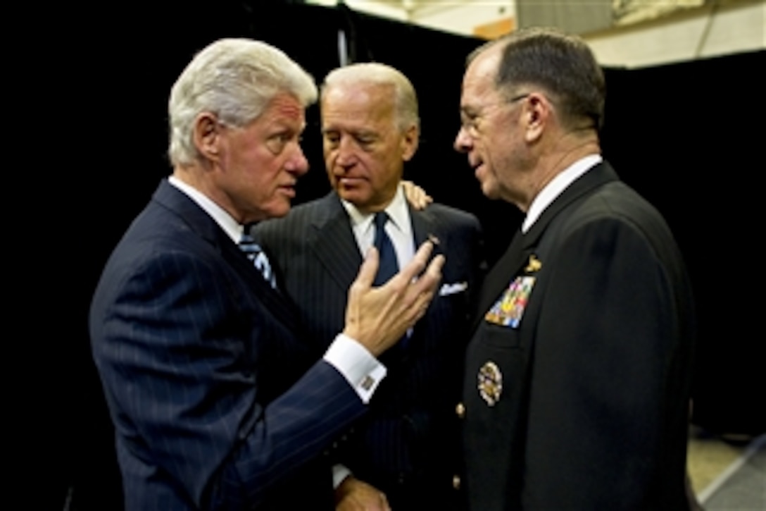Former President Bill Clinton, Vice President Joe Biden and Navy Adm. Mike Mullen, chairman of the Joint Chiefs of Staff, speak backstage at the memorial service for Ambassador Richard C. Holbrooke at the John F. Kennedy Center for Performing Arts in Washington, D.C., Jan. 14, 2011. Holbrooke, the special envoy to Afghanistan and Pakistan, died in December after a nearly 50-year career in foreign service.