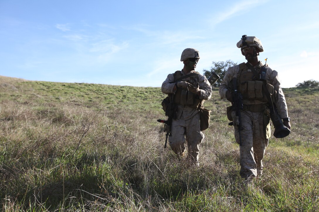 Cpls. Chris Johnsen and Zain Iqbal, both riflemen with Alpha Company, 1st Battalion, 23rd Marine Regiment debrief following their platoon attack at Camp Pendleton’s Range 600, Jan. 14. The training took place as part of the Houston-based infantry battalion’s intermediate location pre-deployment training. The battalion is currently scheduled to deploy to Afghanistan sometime in next month. Iqbal is from Houston. Johnsen is from Clarendon, Texas. ::r::::n::::r::::n::