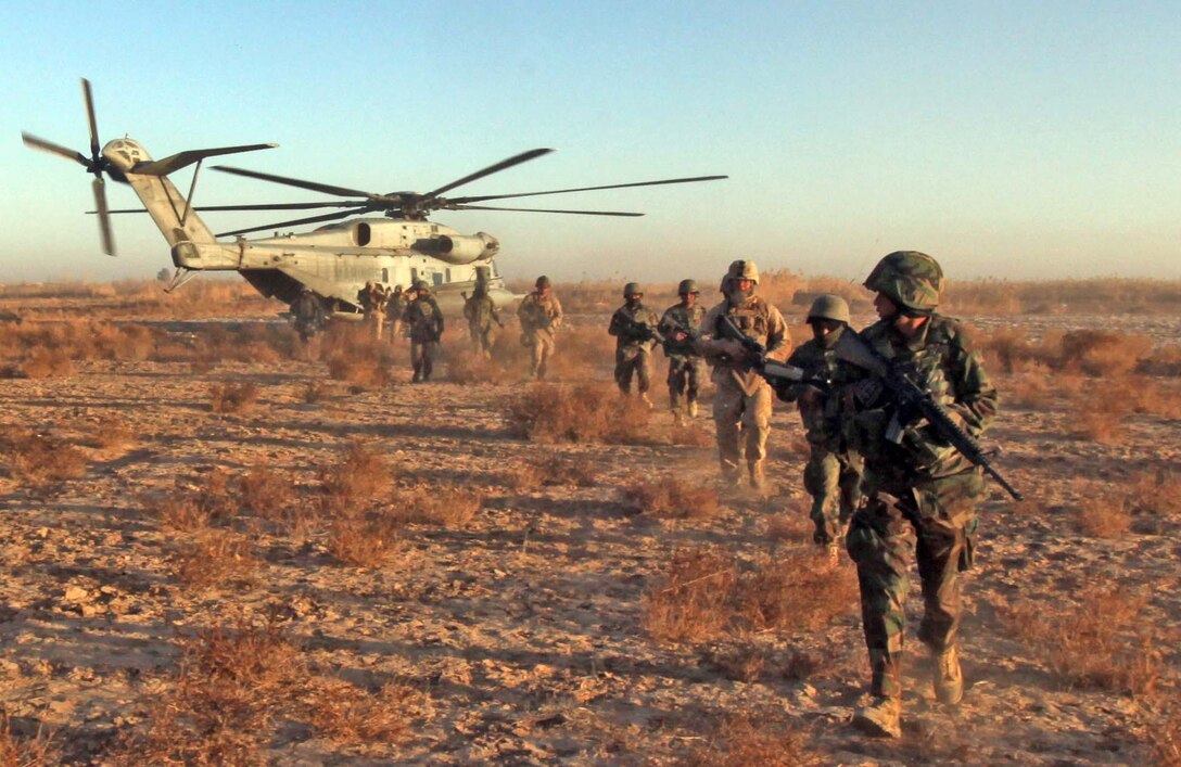 Marines with 2nd Battalion, 9th Marine Regiment and Afghanistan National Army soldiers debark CH-53E helicopter during Operation Integrity, in Marjah, Helmand Province, Afghanistan, Jan. 15. The main purpose of the operation was to successfully cordon off a suspected hotspot for Taliban activity, search for weapon and IED caches, disrupt enemy logistical operations and gather census data on locals in the region of Sistani.