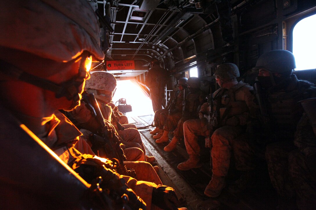 Marines with 2nd Battalion, 9th Marine Regiment and Afghanistan National Army soldiers look out the back of a CH-53E helicopter as it takes them to their insert positions during Operation Integrity in Marjah, Helmand Province, Afghanistan, Jan. 15. The main purpose of the operation was to successfully cordon off a suspected hotspot for Taliban activity, search for weapon and IED caches, disrupt enemy logistical operations and gather census data on locals in the region of Sistani.