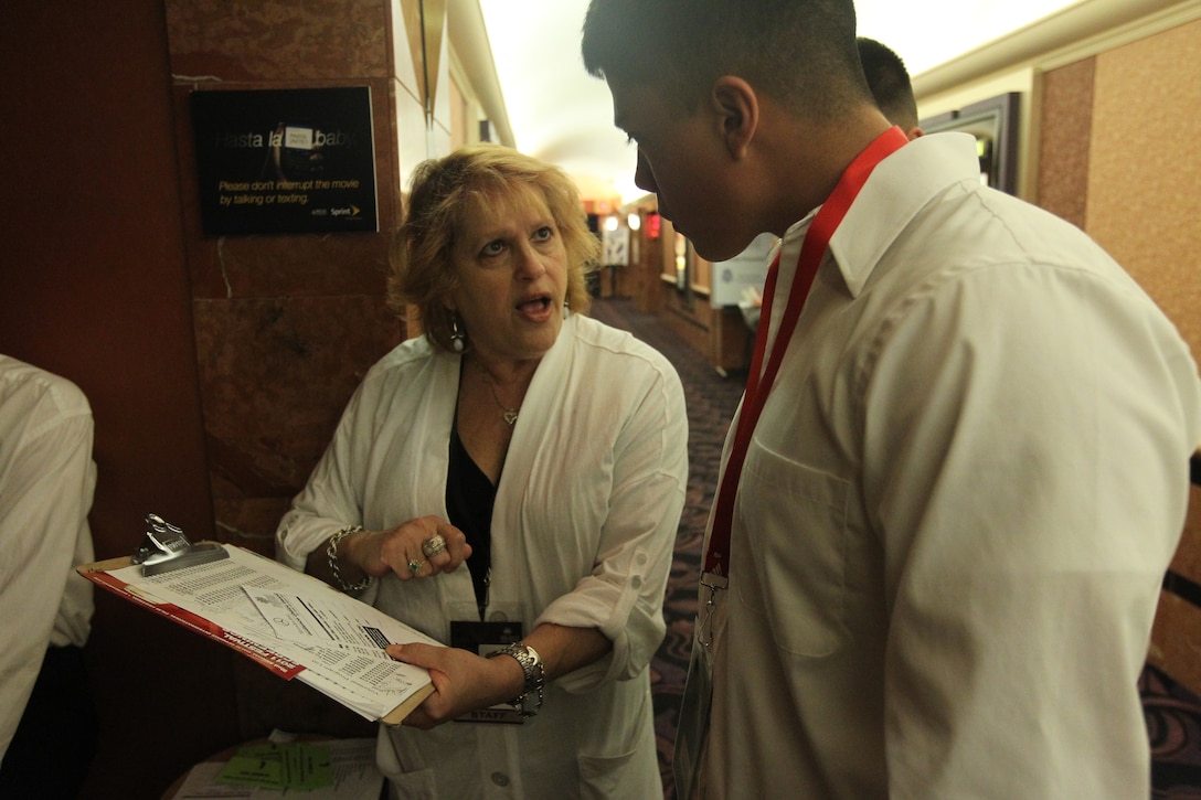 Marine volunteers through the Single Marine Program listen to the volunteer in charge of all the volunteers about the different jobs at the entrance of the showroom while in Regal Cinemas, Palm Springs at the annual Palm Springs International Film Festival Jan. 15, 2011.