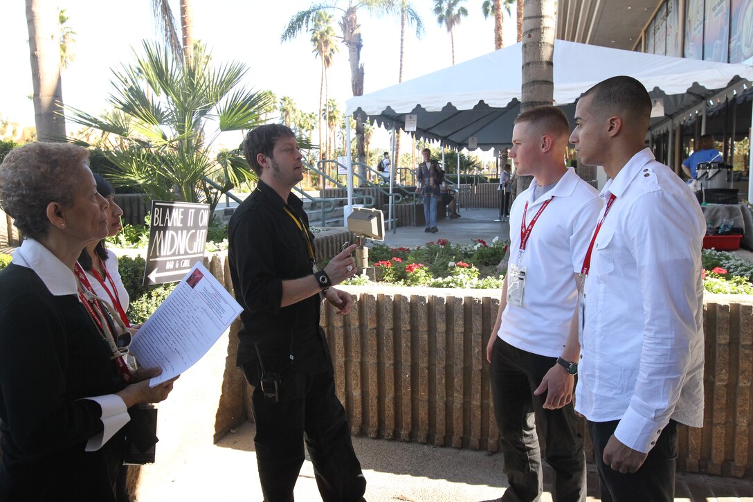 Marine volunteers through the Single Marine Program listen to the volunteer in charge of all the volunteers for the duties they will do while in Regal Cinemas, Palm Springs at the annual Palm Springs International Film Festival Jan. 15, 2011.