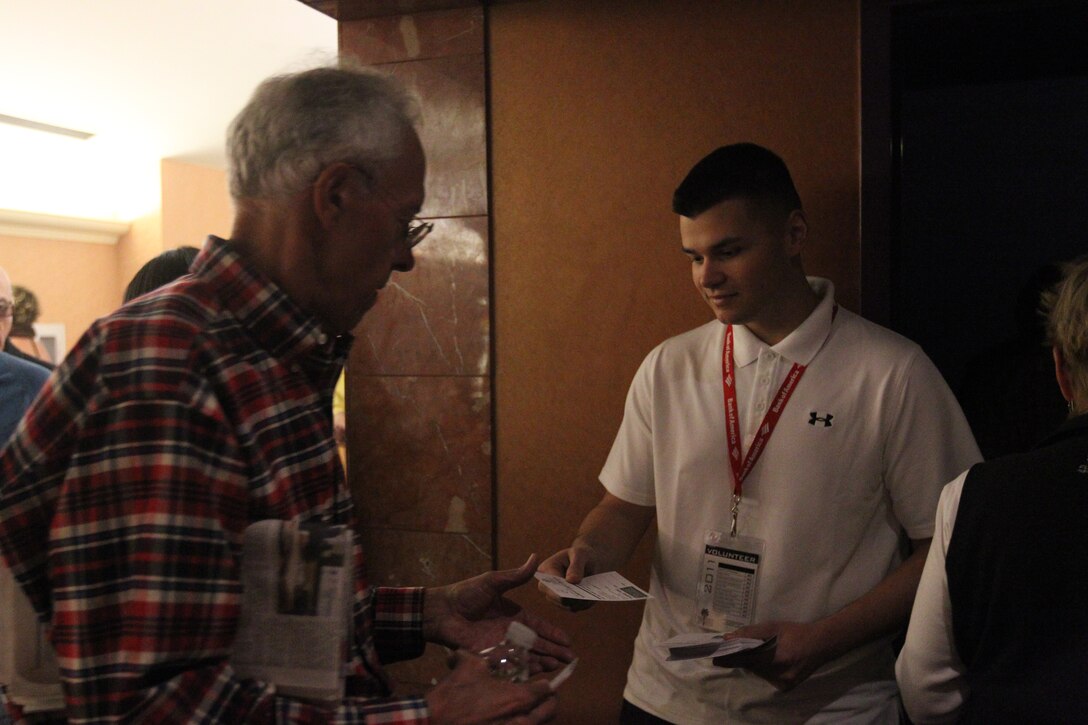 One of the Marine volunteers, with the Single Marine Program, passes out voting ballots to patrons of the annual Palm Springs International Film Festival at Regal Cinemas, in Palm Springs, Calif., Jan. 15, 2011.