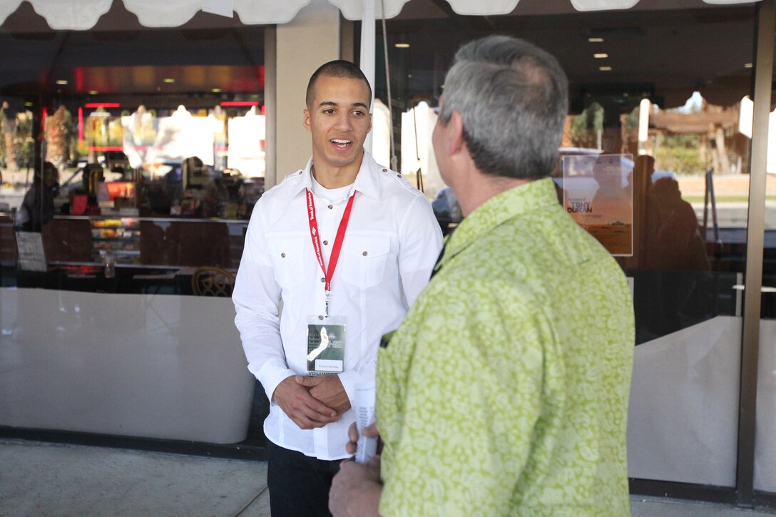 Pfc. Emmanuel Martinez, a student with Marine Corps Communication-Electronics School, talks with one of the movie goers during annual Palm Springs International Film Festival at Regal Cinemas, Palm Springs Jan. 15, 2011.