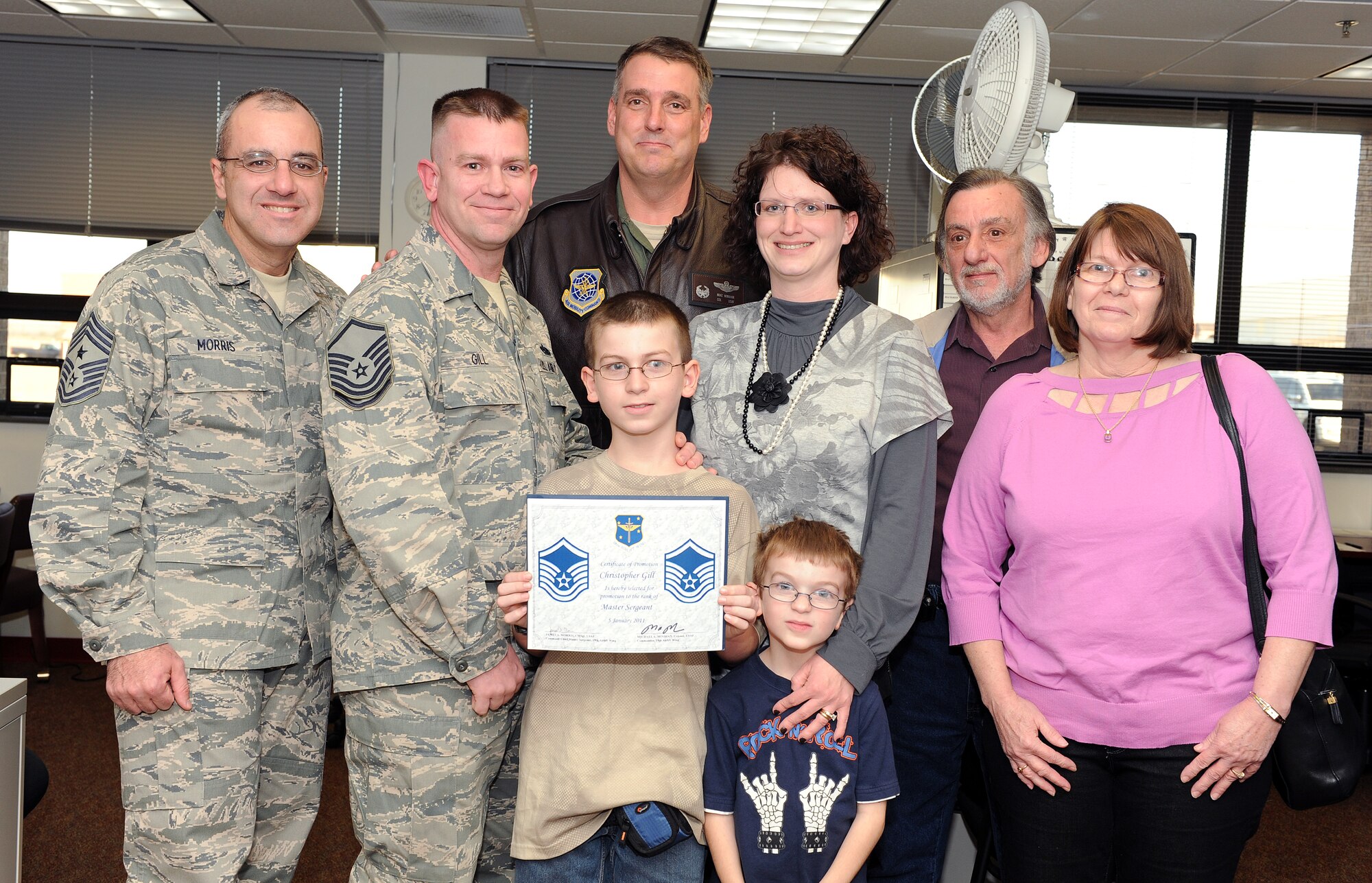 Tech. Sgt. Christopher Gill (second from left), 19th Airlift Wing Safety Office, poses with his family members and base leaders Jan. 5, 2011, at Little Rock Air Force Base, Ark. Sergeant Gill was promoted to master sergeant through the Stripes for Exceptional Performers program. (U.S. Air Force photo by Airman 1st Class Ellora Stewart)