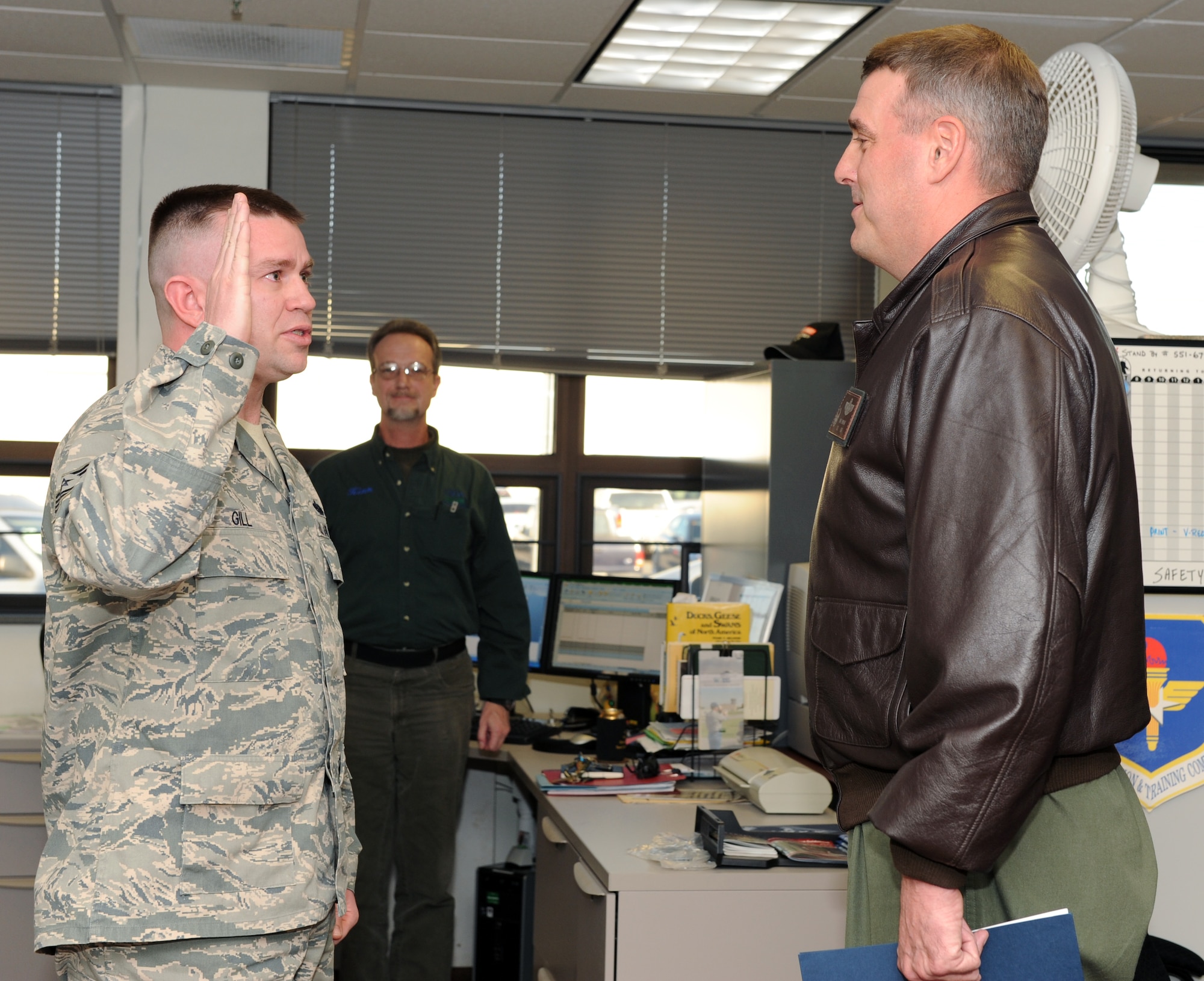 Col. Mike Minihan (right), 19th Airlift Wing commander, administers the enlisted oath to Tech. Sgt. Christopher Gill, 19th AW Safety Office, immediately before he was promoted to master sergeant through the Stripes for Exceptional Performers program Jan. 5, 2011, at Little Rock Air Force Base, Ark. (U.S. Air Force photo by Airman 1st Class Ellora Stewart)