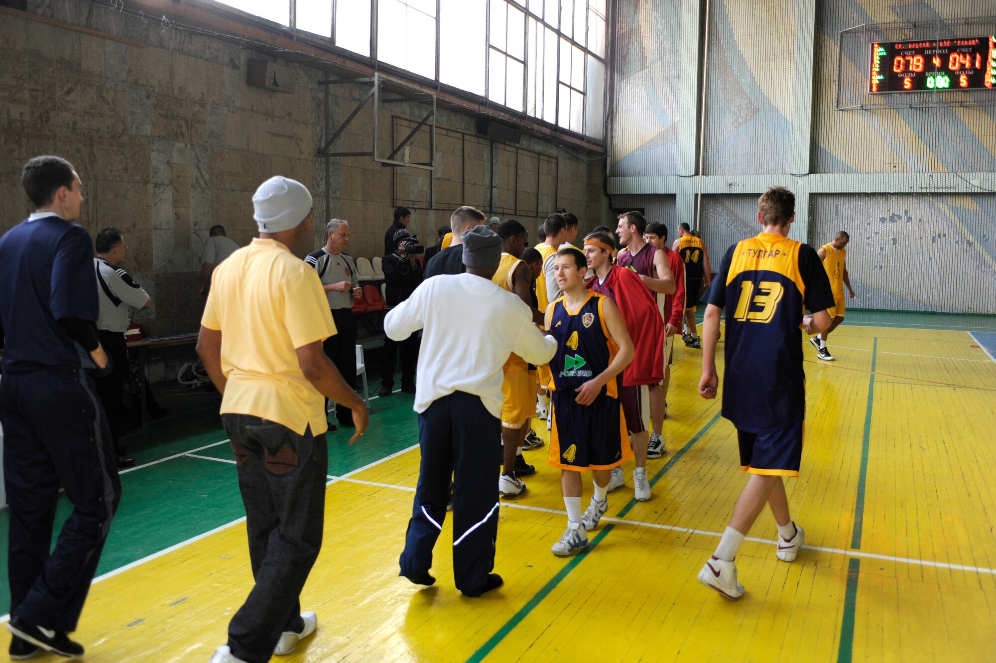 BISHKEK, Kyrgyzstan - The Ak-Bars (Snow Leopards) team and Transit Center at Manas team congratulate each other after their basketball game at the Kojomkul Sports Palace in Bishkek, Jan. 15.  The men's TCM team lost to the Kyrgyz team 78-41.   (U.S. Air Force photo/Tech. Sgt. Jerome C. Baysmore)  