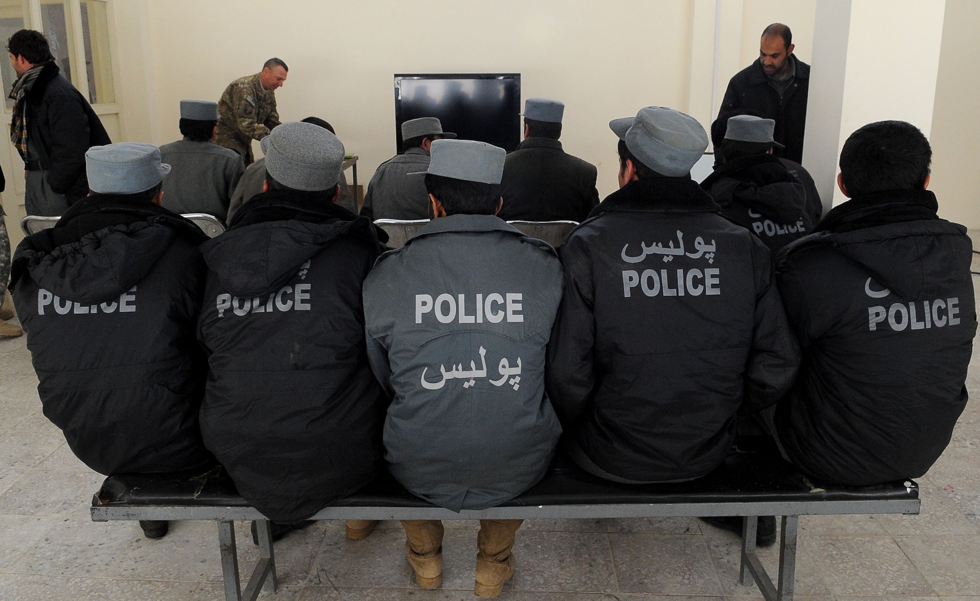 Afghan National Police wait for their police values and ethics training to start in Paryan District, Jan. 9. More than 15 ANP members attended the first of 16 classes, taught by the Paryan District ANP trainer. The class is being taught to promote awareness of ethical behavior and how it impacts law enforcement. (U.S. Air Force photo by Senior Airman Amber Ashcraft)