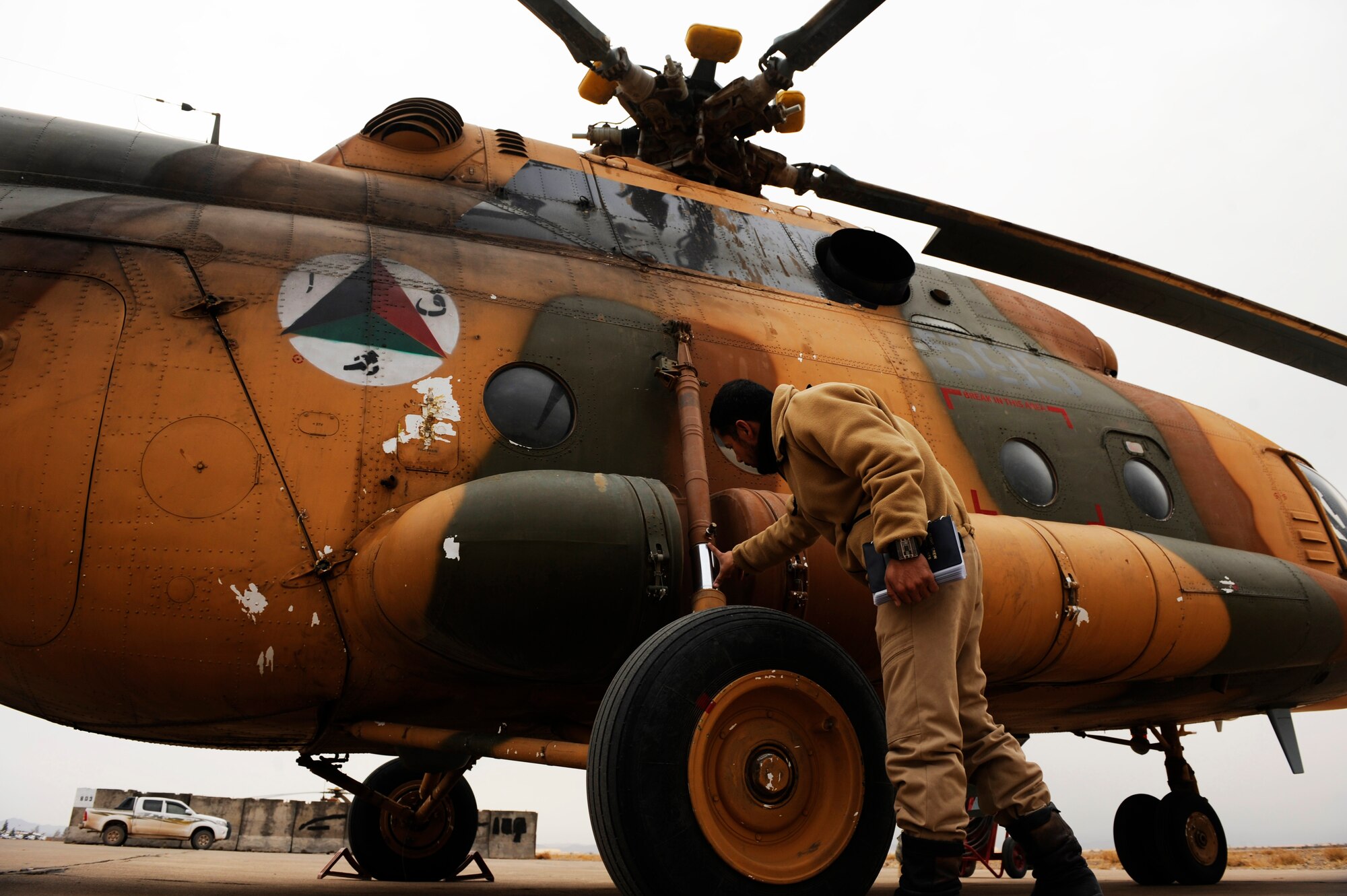 Afghan Air Force Capt. Hamid conducts post-flight checks after a proficiency flight at Shindand Air Base, Afghanistan, Jan 10, 2011.  Capt. Hamid is part of a pilot training program at Shindand AB that will teach him the skills needed to become an Mi-17 aircraft commander.  (U.S. Air Force Photo/Staff Sgt. Eric Harris) (RELEASED)