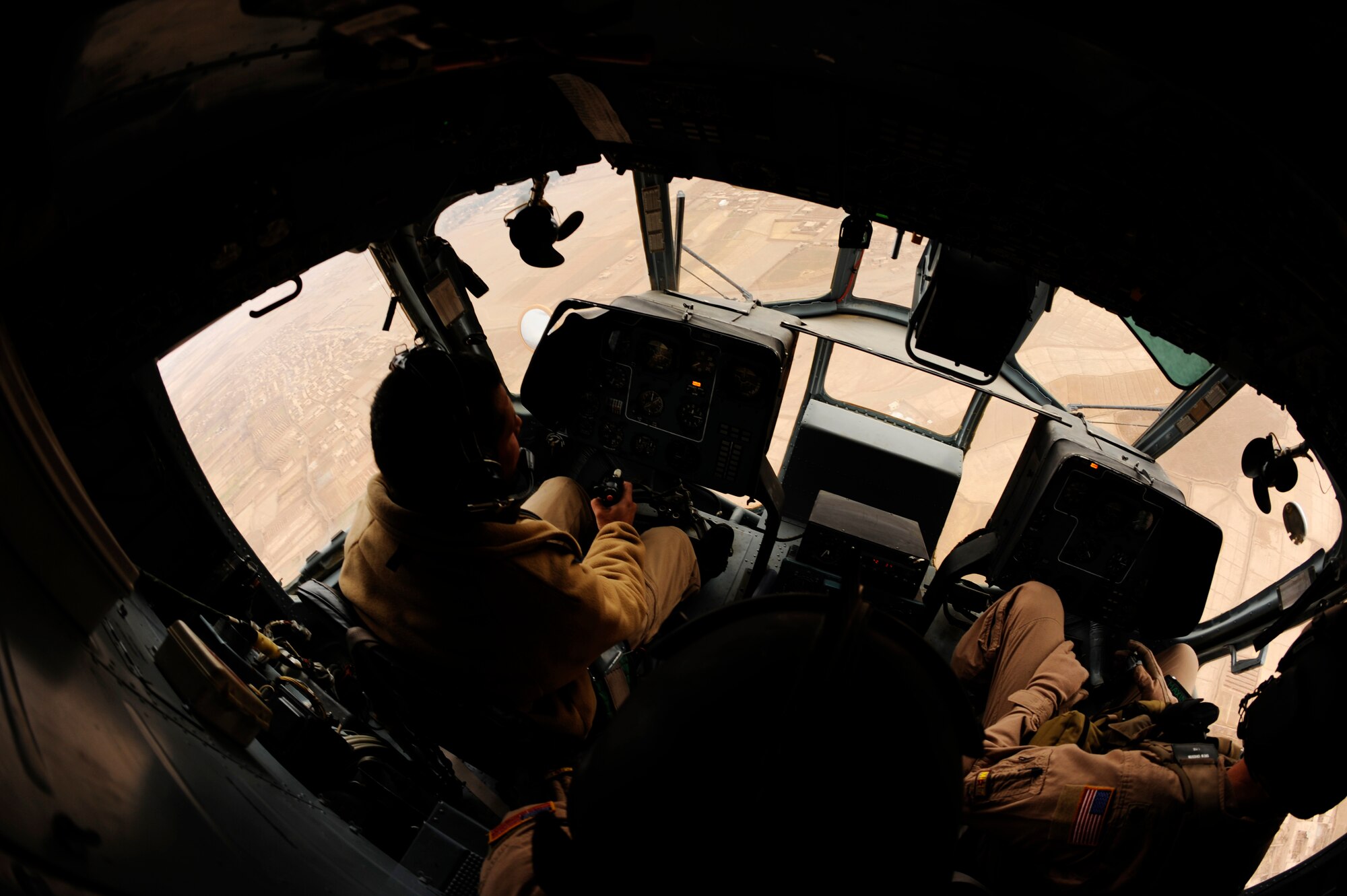 Afghan Air Force Capt. Hamid practices emergency procedures with instruction from U.S Air Force Maj. Drew Grigson, 444th Air Expeditionary Advisory Squadron, during a proficiency flight aboard an Mi-17 helicopter at Shindand Air Base, Afghanistan, Jan 10, 2011.  Capt. Hamid is part of the first class of pilots to attend a pilot training course taught by U.S. Air Force Airmen from the 444th AEAS at Shindand AB.  (U.S. Air Force Photo/Staff Sgt. Eric Harris) (RELEASED)