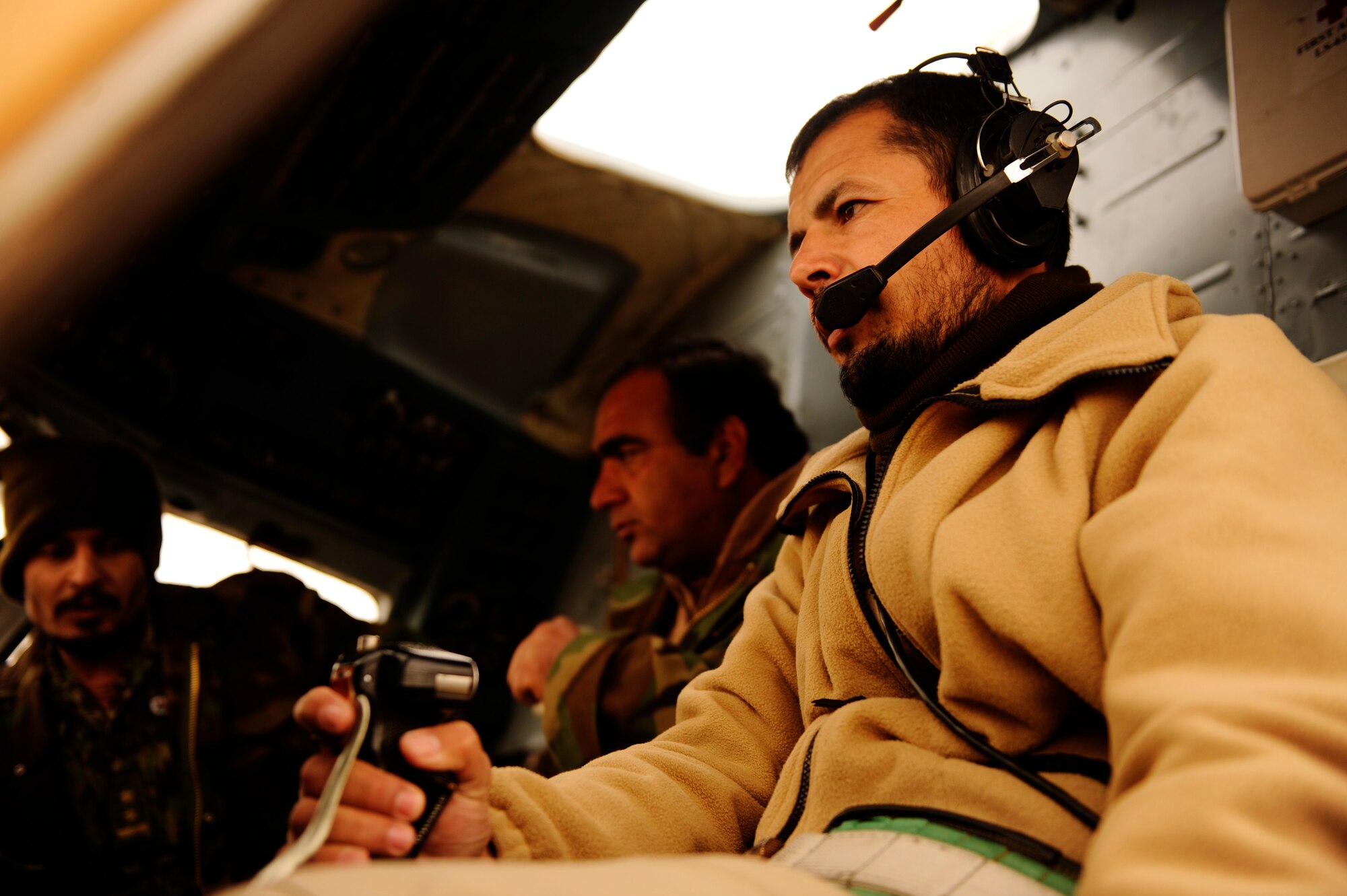 Afghan Air Force Capt. Hamid conducts pre-flight checks aboard an Mi-17 helicopter before a proficiency flight at Shindand Air Base, Afghanistan, Jan 10, 2011.  Captain Hamid is part of a pilot training program at Shindand AB that will teach him the skills needed to become an Mi-17 aircraft commander.  (U.S. Air Force Photo/Staff Sgt. Eric Harris) (RELEASED)