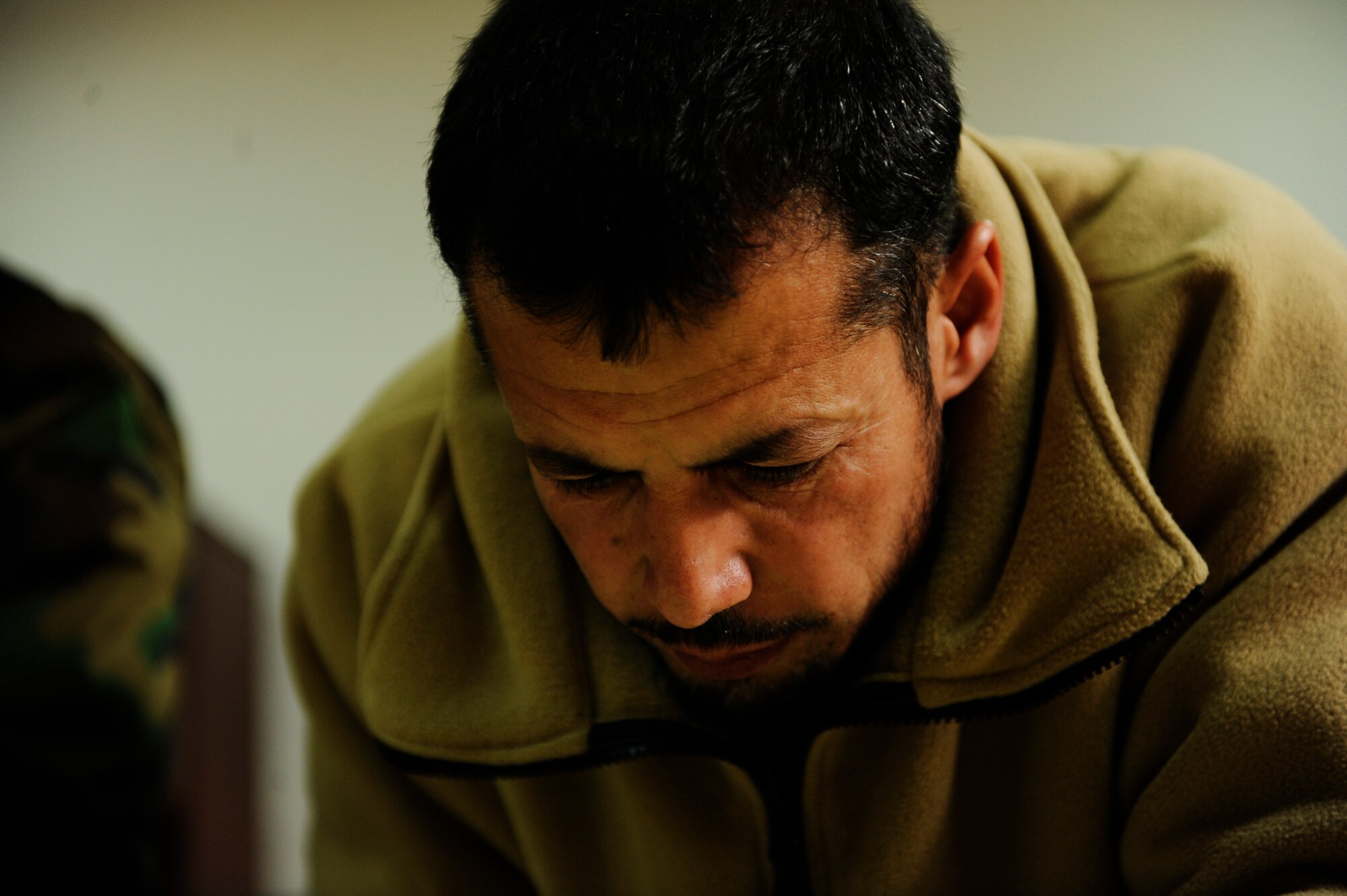 Afghan Air Force Capt. Hamid completes practice problems during a mission planning course at Shindand Air Base, Afghanistan, Jan 9, 2011.  Captain Hamid is part of the first group of Afghan pilots to attend the pilot training program at Shindand AB.  (U.S. Air Force Photo/Staff Sgt. Eric Harris) (RELEASED)