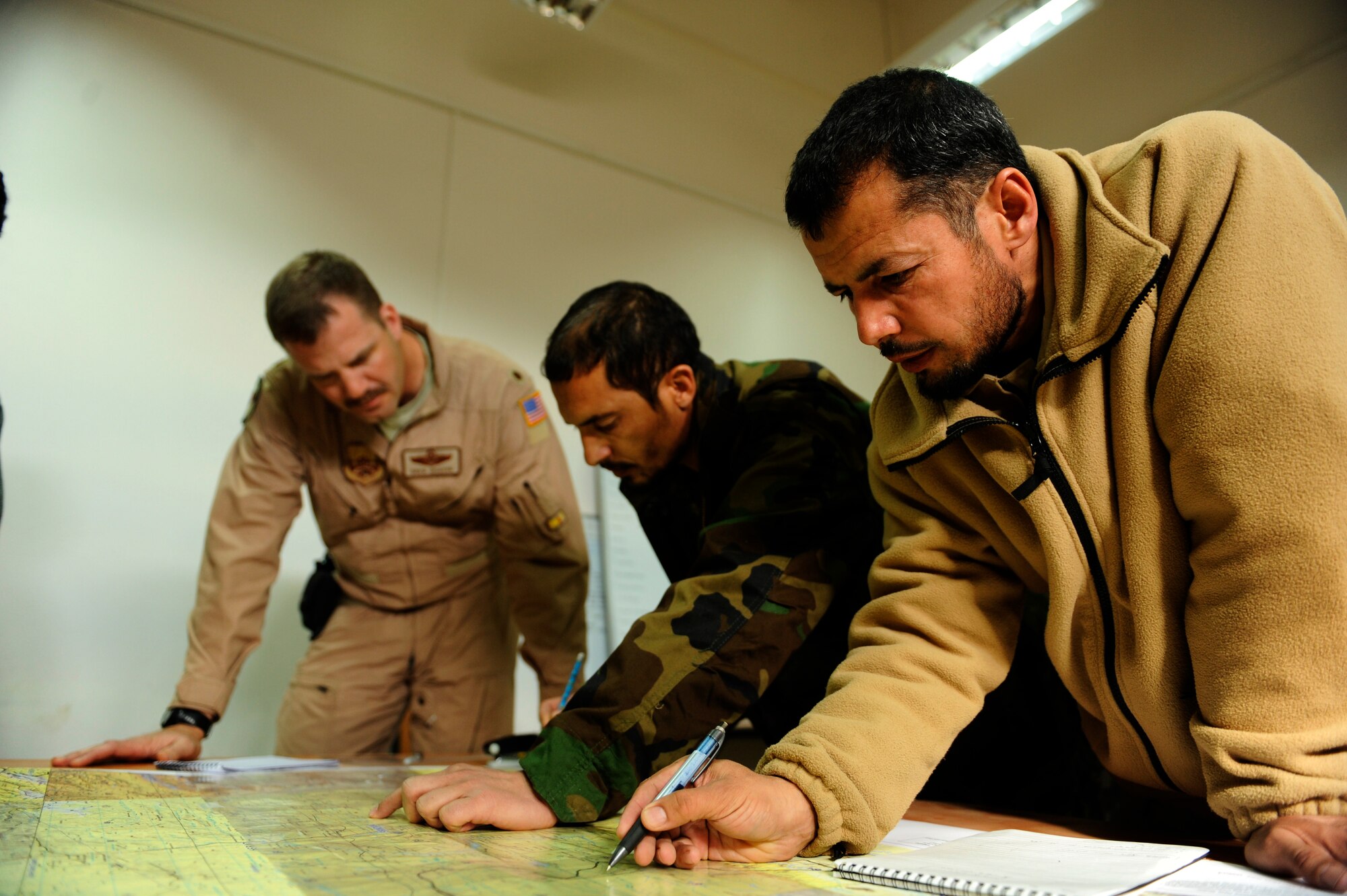Afghan Air Force Mi-17 pilots complete practice problems during a mission planning class taught by U.S. Air Force Major Drew Grigson, 444th Air Expeditionary Advisory Squadron, at Shindand Air Base, Afghanistan, Jan 9, 2011.  The Afghan pilots are learning the skills necessary to become aircraft commanders.  (U.S. Air Force Photo/Staff Sgt. Eric Harris) (RELEASED)