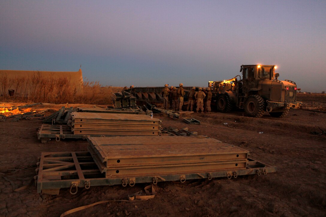 Marines of 8th Engineer Support Battalion, 1st Marine Logistics Group (Forward), construct a bridge over a canal in Garmser District, Helmand province, Afghanistan, Jan. 15, 2011. 8th ESB Marines provide engineering support for coalition forces throughout the province in support of the International Security Assistance Force.