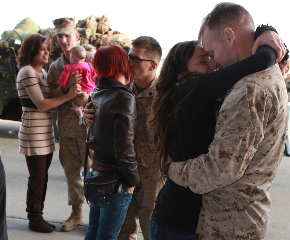 Three couples reunite after a bus dropped off the 19 Marine Heavy Helicopter Squadron 366 Marines who returned home after a seven-month deployment to Afghanistan Jan. 16. The remaining Hammerheads are scheduled to return home in February.