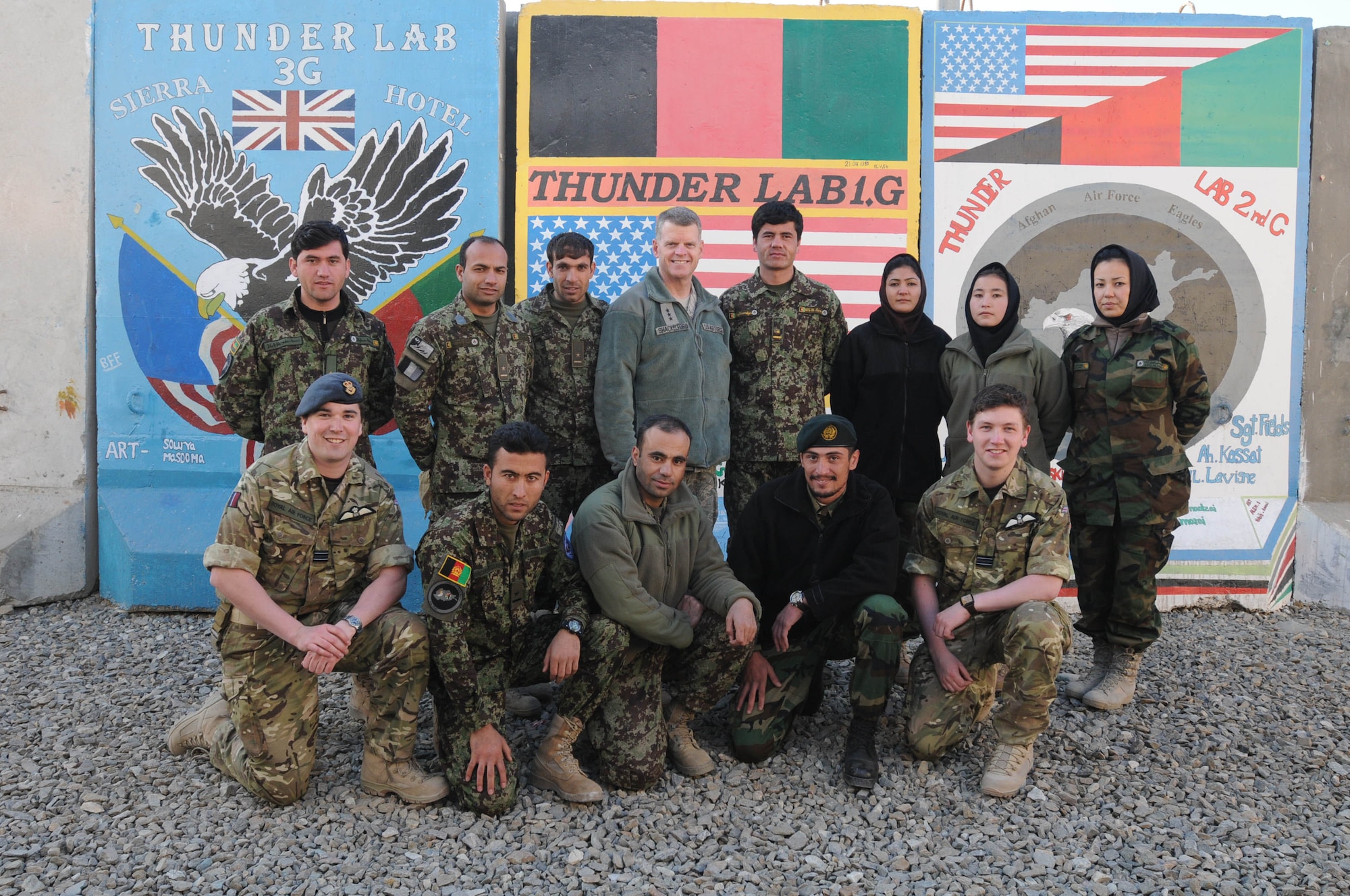 KABUL, Afghanistan - Lt. Gen. Mark Shackelford poses with a photo with members of the Afghan Air Force and British Royal Air Force during his tour of the Afghan Air Force English immersion lab known as the "Thunder Lab" at Kabul, Afghanistan Jan. 15. (U.S. Air Force photo by Airman 1st Class Lausanne Morgan/RELEASED).