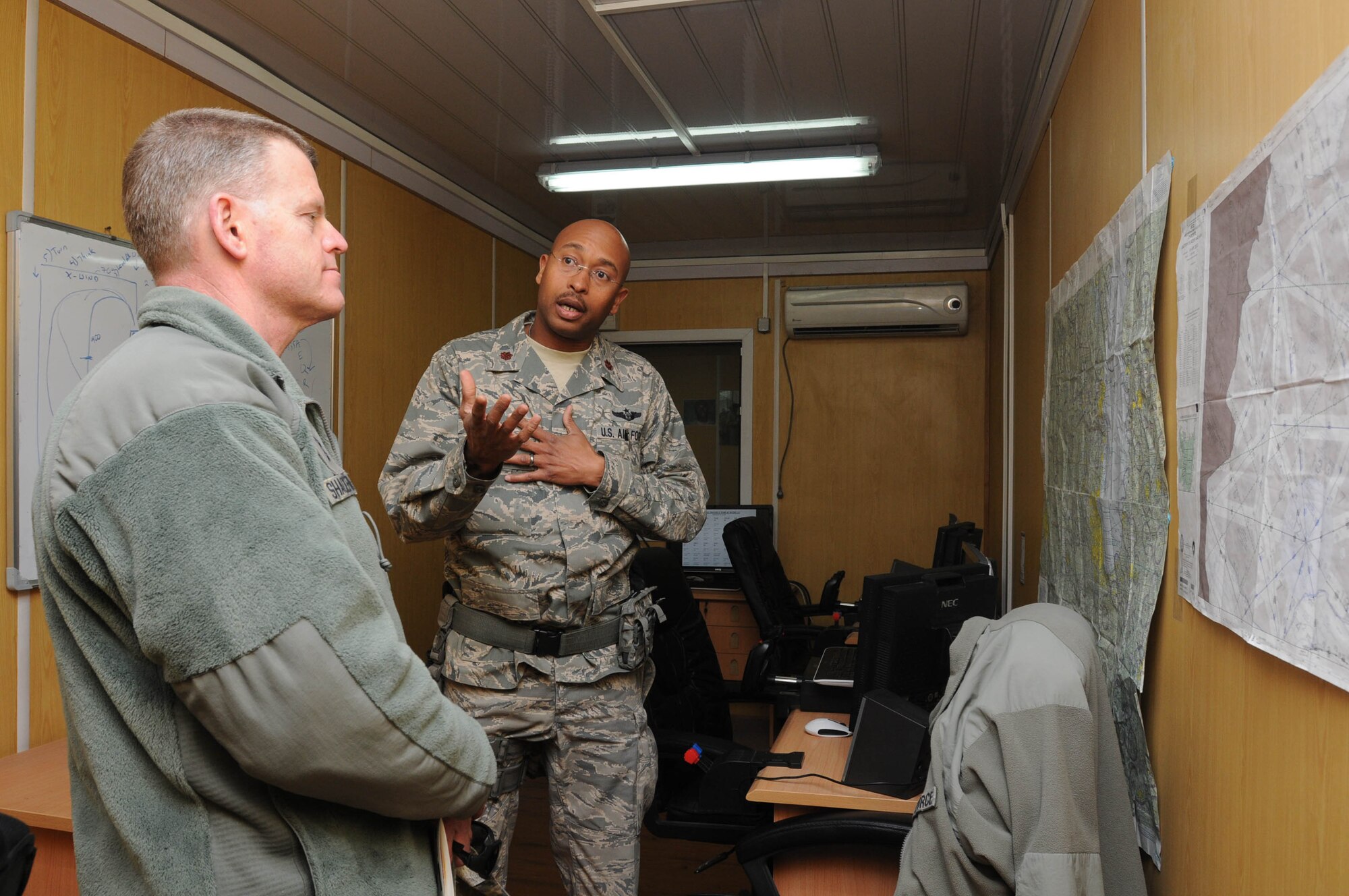 KABUL, Afghanistan - Maj. Patrick Stovall, Thunder Lab Flight Simulator Instructor gives Lt. Gen. Mark Shackelford a tour of the flight simulator room during Gen. Shackelford's tour of the Afghan Air Force English immersion lab known as the "Thunder Lab" at Kabul, Afghanistan Jan. 15. (U.S. Air Force photo by Airman 1st Class Lausanne Morgan/RELEASED).