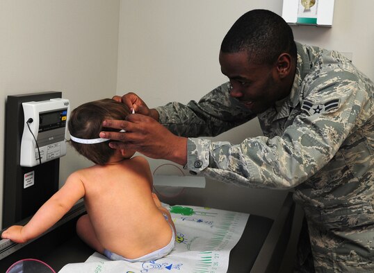 MOODY AIR FORCE BASE, Ga. -- Airman 1st Class Kerji Hunt, 23rd Medical Group aerospace medicine technician, measures the head circumference of Tyler, son of Capt. Edward Wineland and wife Tamara, during a baby wellness checkup. At each checkup, the doctor will measure the baby’s length, weight and head circumference. Then they will plot those numbers on a chart of national averages for babies of the same age and sex. In the end, they will tell you what percentile your child is in. (U.S. Air Force photo/Senior Airman Stephanie Mancha)(RELEASED)

