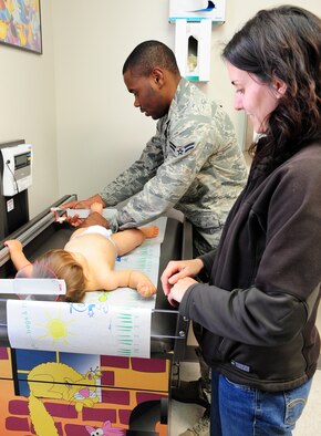 MOODY AIR FORCE BASE, Ga. -- Airman 1st Class Kerji Hunt, 23rd Medical Group aerospace medicine technician, takes the height of  Tyler, son of Capt.  Edward Wineland and wife Tamara, during a baby wellness checkup. These measurements are general guides to the doctor assess a baby’s growth. (U.S. Air Force photo/Senior Airman Stephanie Mancha)(RELEASED)