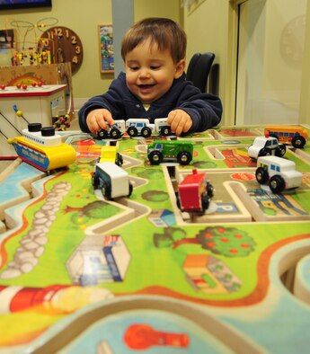 MOODY AIR FORCE BASE, Ga. -- Tyler, son of Capt. Edward Wineland and wife Tamara, plays with toy cars in the 23rd Medical group pediatrics waiting area, as he waits with his mom Tamara to be seen for his 1-year- old baby wellness checkup.  The pediatrics waiting area is full of toys for children to play with while they wait to be called back into the examination room. (U.S. Air Force photo/Senior Airman Stephanie Mancha)(RELEASED)
