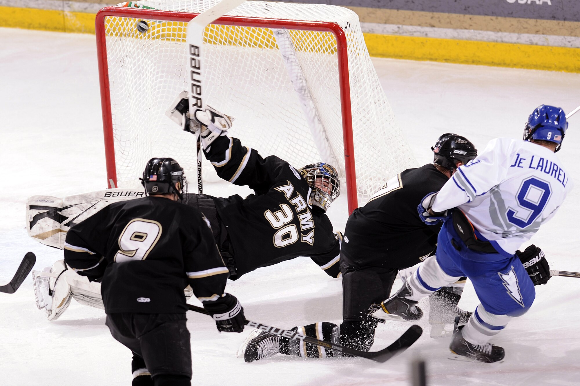 Air Force sophomore forward Kyle De Laurell just misses a shot on goal against Army goalie Ryan Leets during the Falcons' game against the Black Knights at the Cadet Ice Arena Jan. 15, 2011. Army held off a late rally by the Falcons in the Jan. 15 game to defeat Air Force, 5-4. (U.S. Air Force photo/Mike Kaplan)