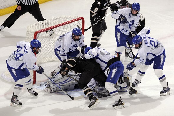 Falcons goalie Jason Torf successfully defends the goal during a flurry against the Army Black Knights at the Cadet Ice Arena in Colorado Springs, Colo., Jan 15, 2011. Army went on to defeat the Falcons 5-4. Torf is a native of Hermosa Beach, Calif. (U.S. Air Force photo/Mike Kaplan)