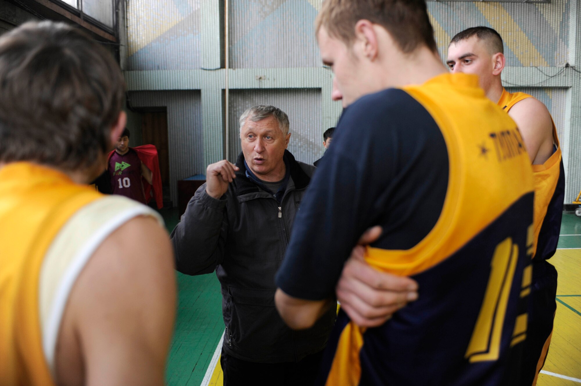 BISHKEK, Kyrgyzstan - Ak-Bars (Snow Leopards) Coach Vladimir Trunov goes over his game plan during at the Kojomkul Sports Palace in Bishkek, Jan. 15.  The men's TCM team lost to the AK-Bars 78-41.   (U.S. Air Force photo/Tech. Sgt. Jerome C. Baysmore)