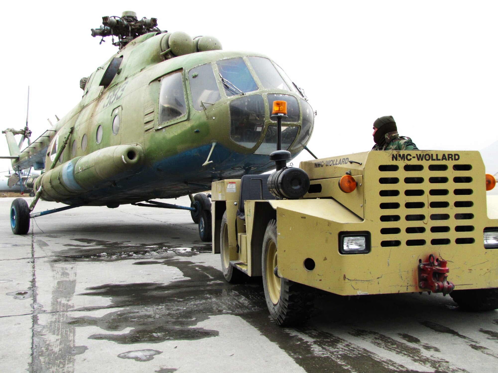 An Mi-17 is towed into a hanger where it will undergo the first local overhaul of an Afghan Air Force aircraft. (Photo by Mass Communications Specialist 2nd Class Vladimir Potapenko/RELEASED).